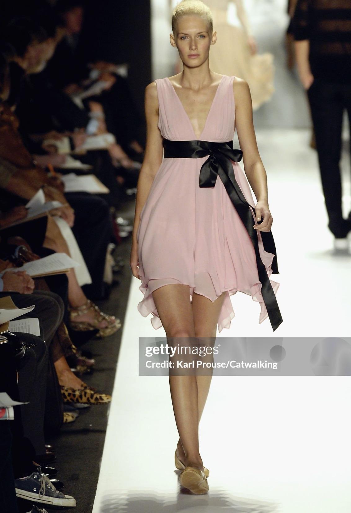 Presenting a fabulous pink chiffon ballerina dress from the Michael Kors Spring/Summer 2007 runway collection. Crafted from flowing pink chiffon, this elegant dress is accented by a contrasting black satin ribbon trim, tied into a delicate bow at