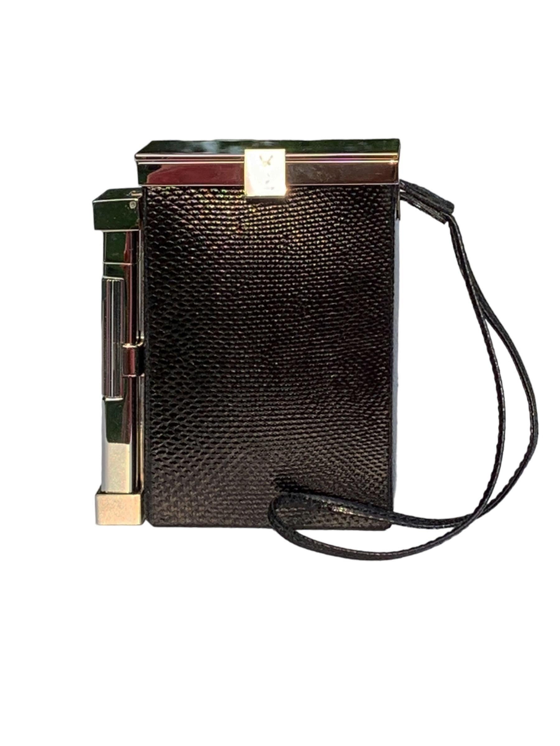 Tom Ford for Yves Saint Laurent
Spring/Summer 2001 Collection
An Yves Saint Laurent snake leather cigarette case and lighter. This item features a chrome tone latched hinged top that opens to a space suitable for a pack of cigarettes. Another