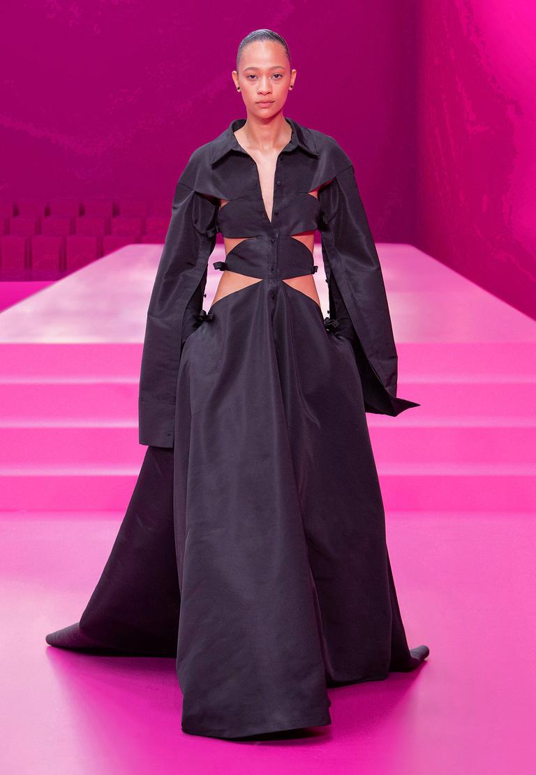 One of the most distinctive and imaginative fashions of the Valentino fall 2022 runway.   Styled with imagination and high style by Pierpaolo Piccioli fashioned in weighty black silk taffetta.   Fitted bodice boasts side cutouts with bow adornments.