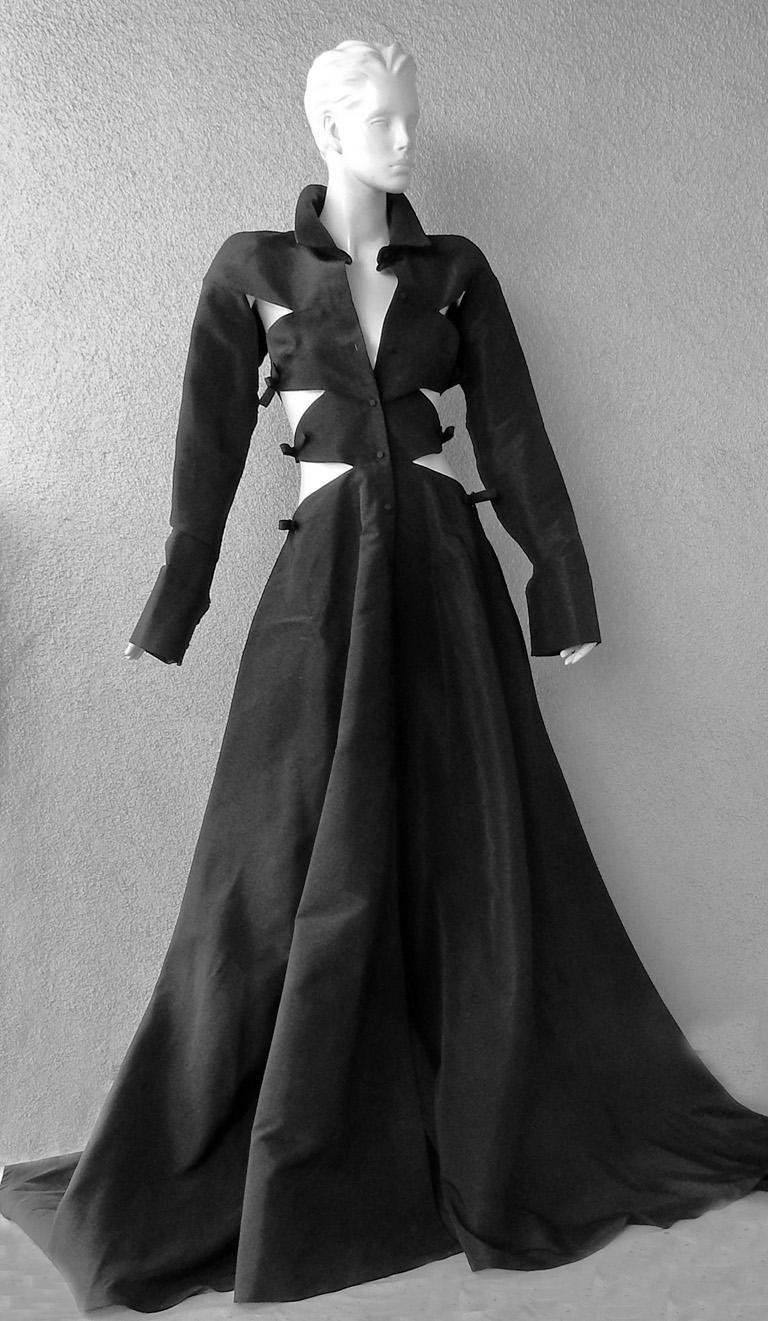 One of the most distinctive and imaginative fashions of the Valentino fall 2022 runway.   Styled with imagination and high style by Pierpaolo Piccioli fashioned in weighty black silk taffetta.   Fitted bodice boasts side cutouts with bow adornments.