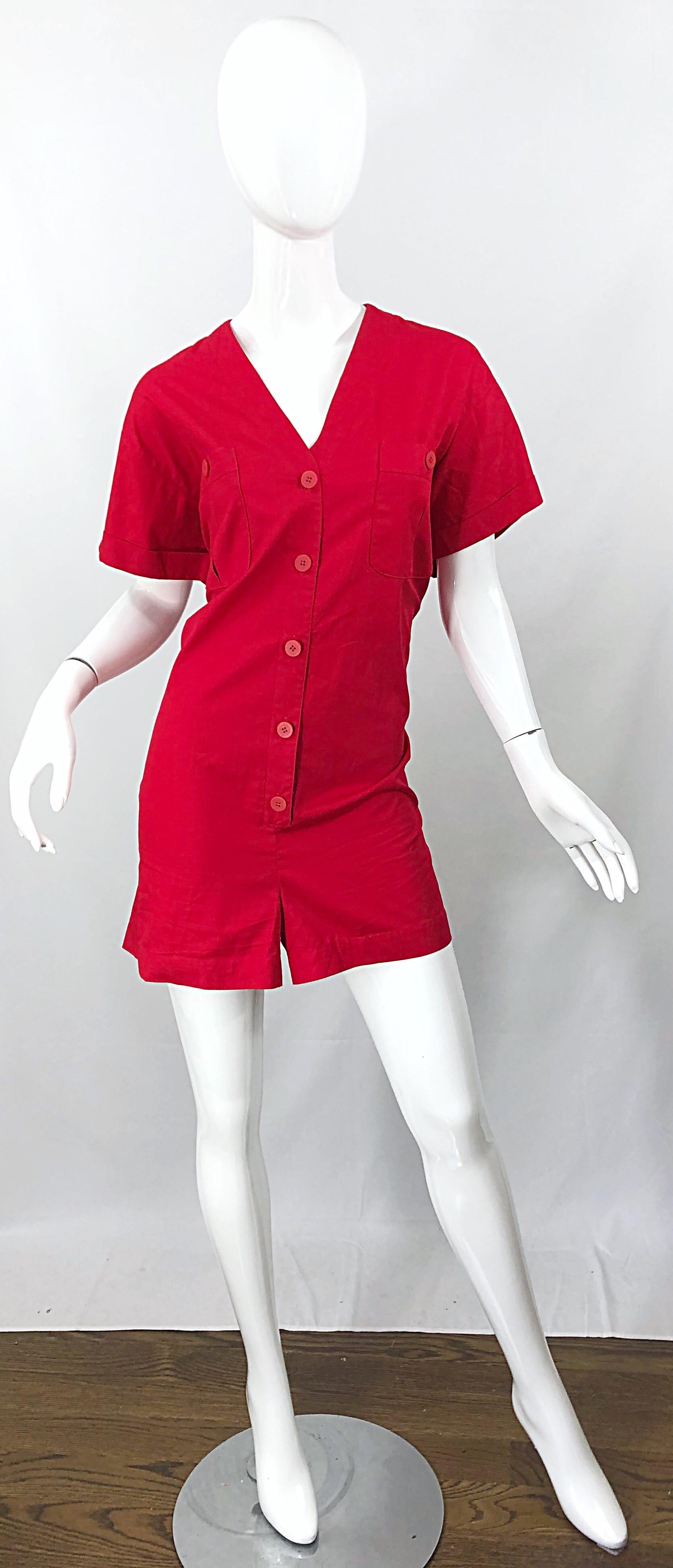 Brand new with tags CHIRSTIAN DIOR romper / jumpsuit in rare Size 14 ! Soft cotton lipstick red fabric buttons up the front, and at each breast pocket. Flattering v-neck collar with cuffed sleeves. Pockets also at each side of the waist. Can easily