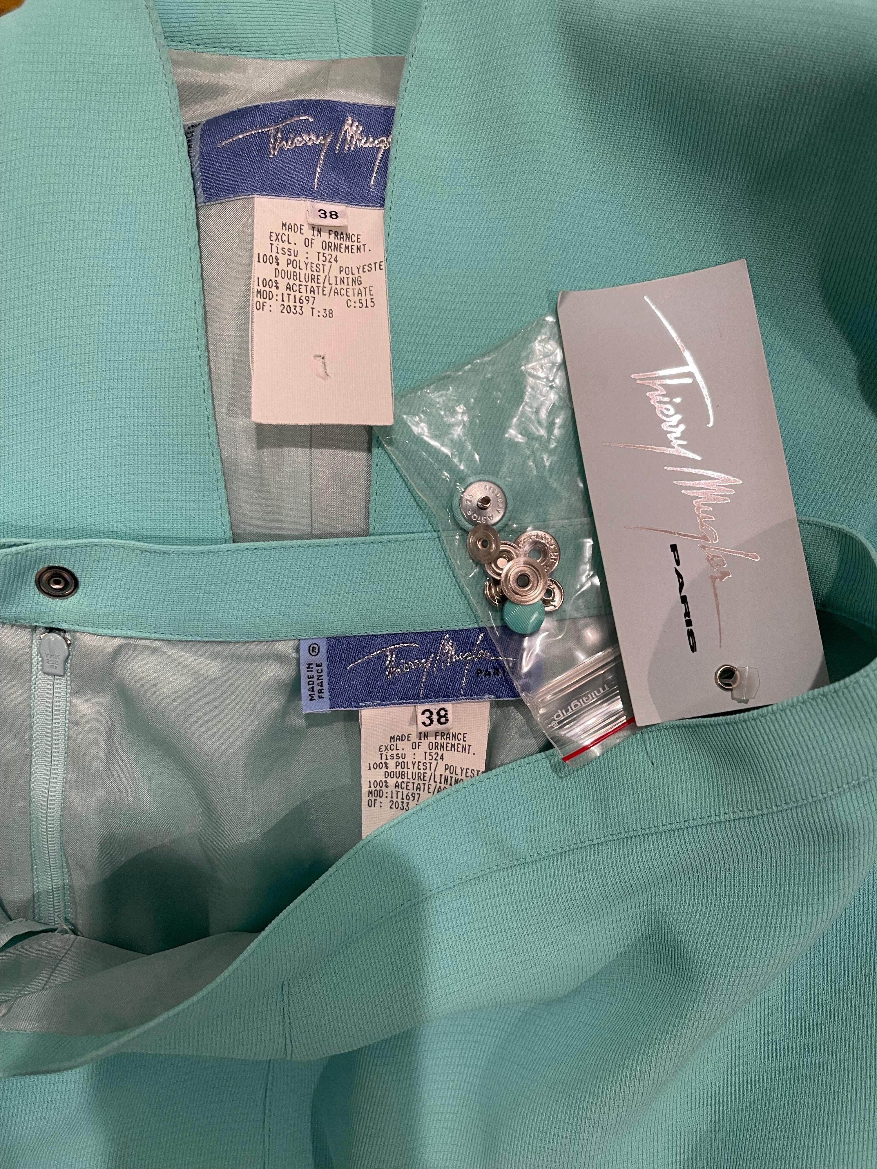 Chic brand new with tags THIERRY MUGLER mint blue skirt suit ! Jacket snaps up the front, and ties at center waist. Slits at each sleeve cuff. High waisted mini pencil skirt has zipper up the side with hook-and-eye closure.
Both pieces great