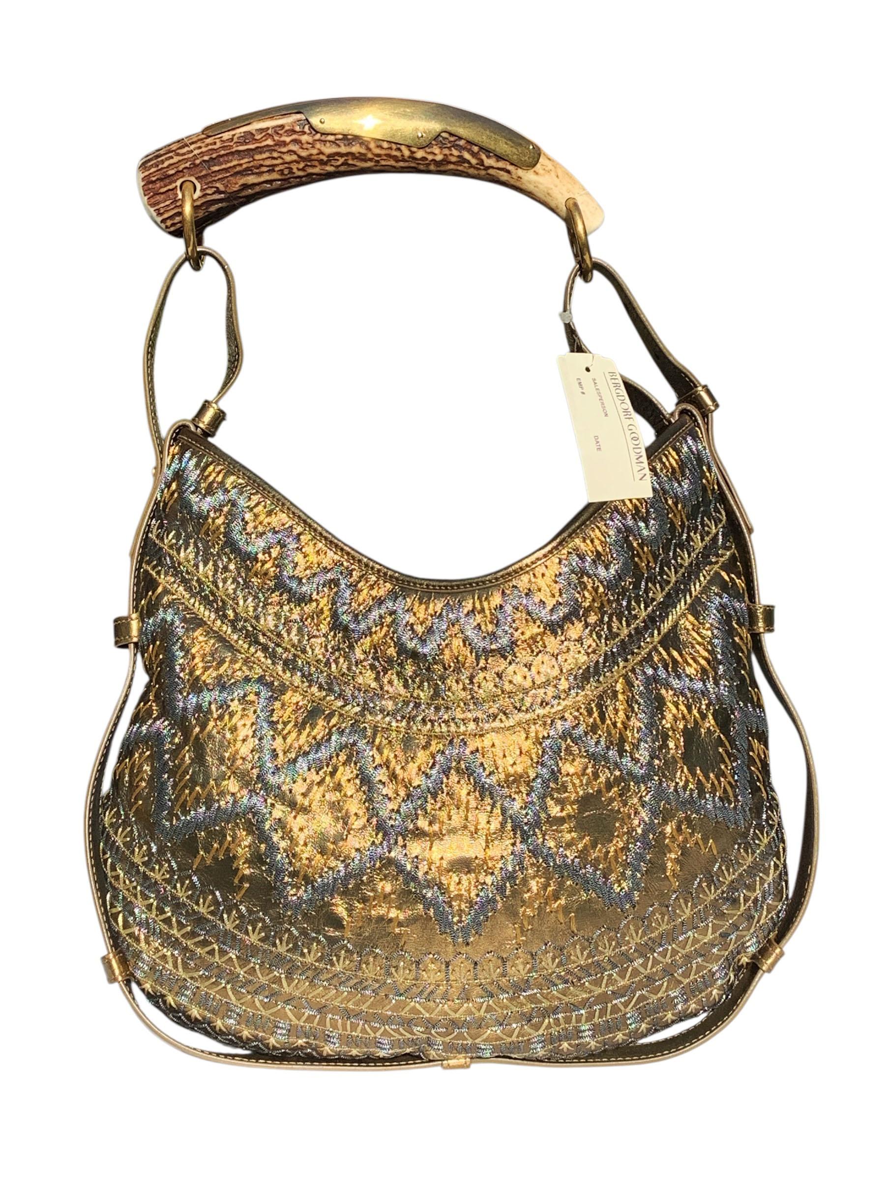 Tom Ford for Yves Saint Laurent *Mombasa* Leather Shoulder Bag
S/S 2004 Collection
Serial number: 186121 / 213317
Material 
Finish: Gold leather body with intricate silver-and-gold metallic embroidery detailing.
Handle/Hardware: Signature