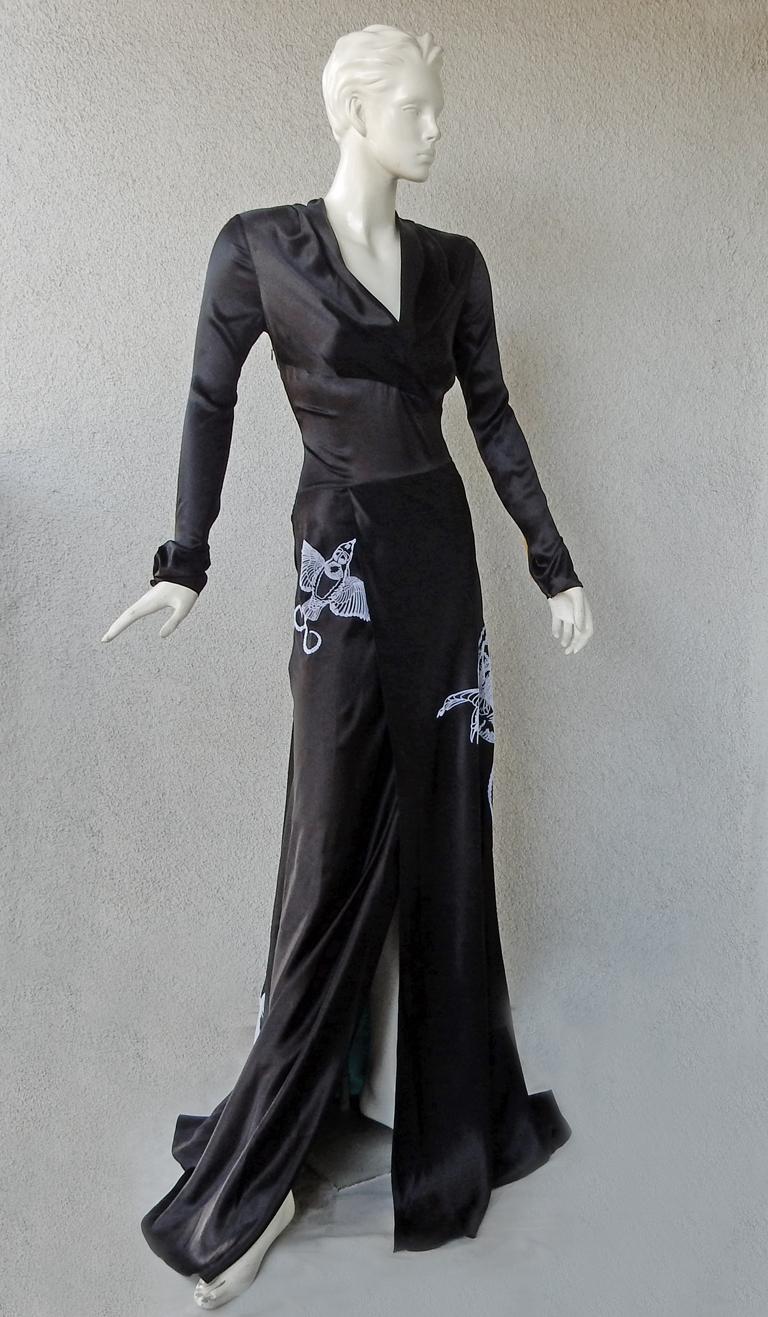 Vionnet rich black deco inspired gown.   Features bias cut full skirt accented with a panel of deep blue turquoise;  Large flocked birds (possibly swallows) fashioned in velvet and strategically placed.  V neck bodice with asymmetric inserted panel