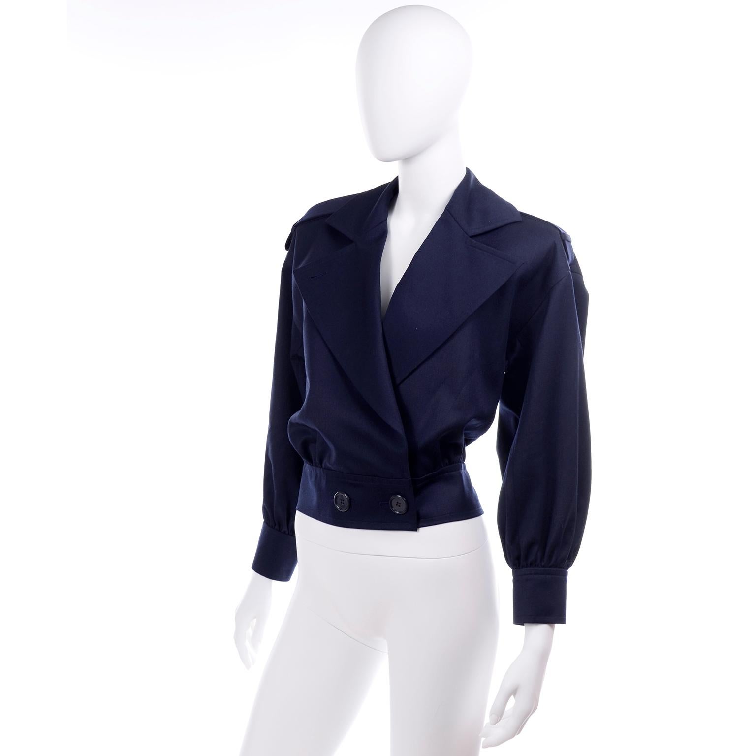 This is a wonderful, deadstock, Yves Saint Laurent Variation jacket in navy blue summer weight wool. The jacket is fully lined and closes with two buttons at the waist. There are epaulettes and the hem and cuffs are gathered. A great, unworn jacket