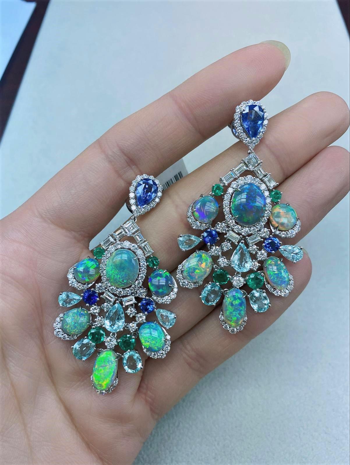 The Following Items we are offering is a Rare Important Spectacular and Brilliant 18KT Gold Large Gorgeous Black Opal, Emerald, Paraiba, Blue Sapphire and Diamond Dangle Earrings. Earrings consists of Rare Fine Magnificent Black Opals surrounded and