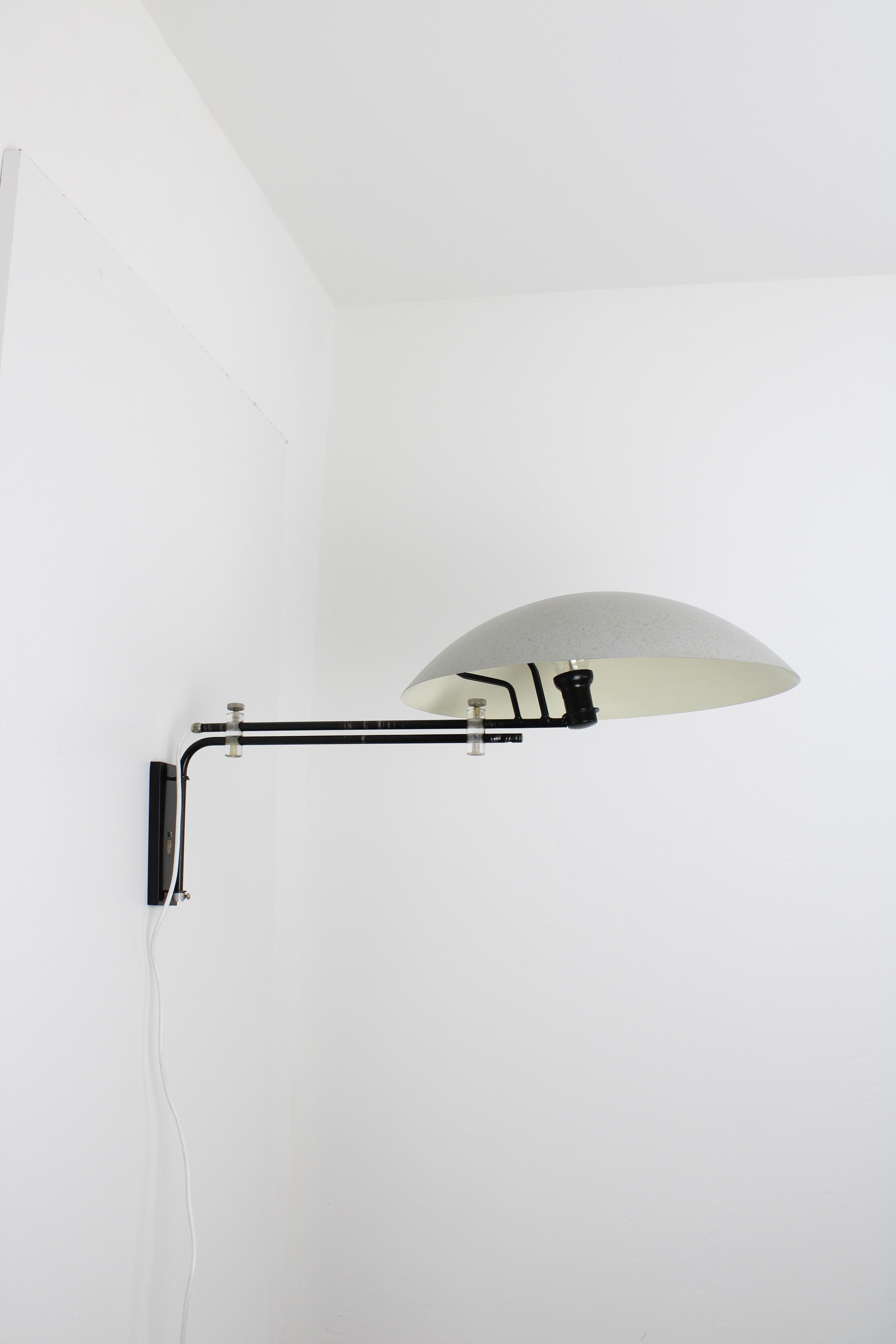 Wall lamp, model NX23. Designed by Louis Christiaan Kalff in 1954. Manufactured by lighting company Philips in the Netherlands. This large wall lamp has a modernist design and is adjustable in multiple ways. The condition of this lamp is good. There