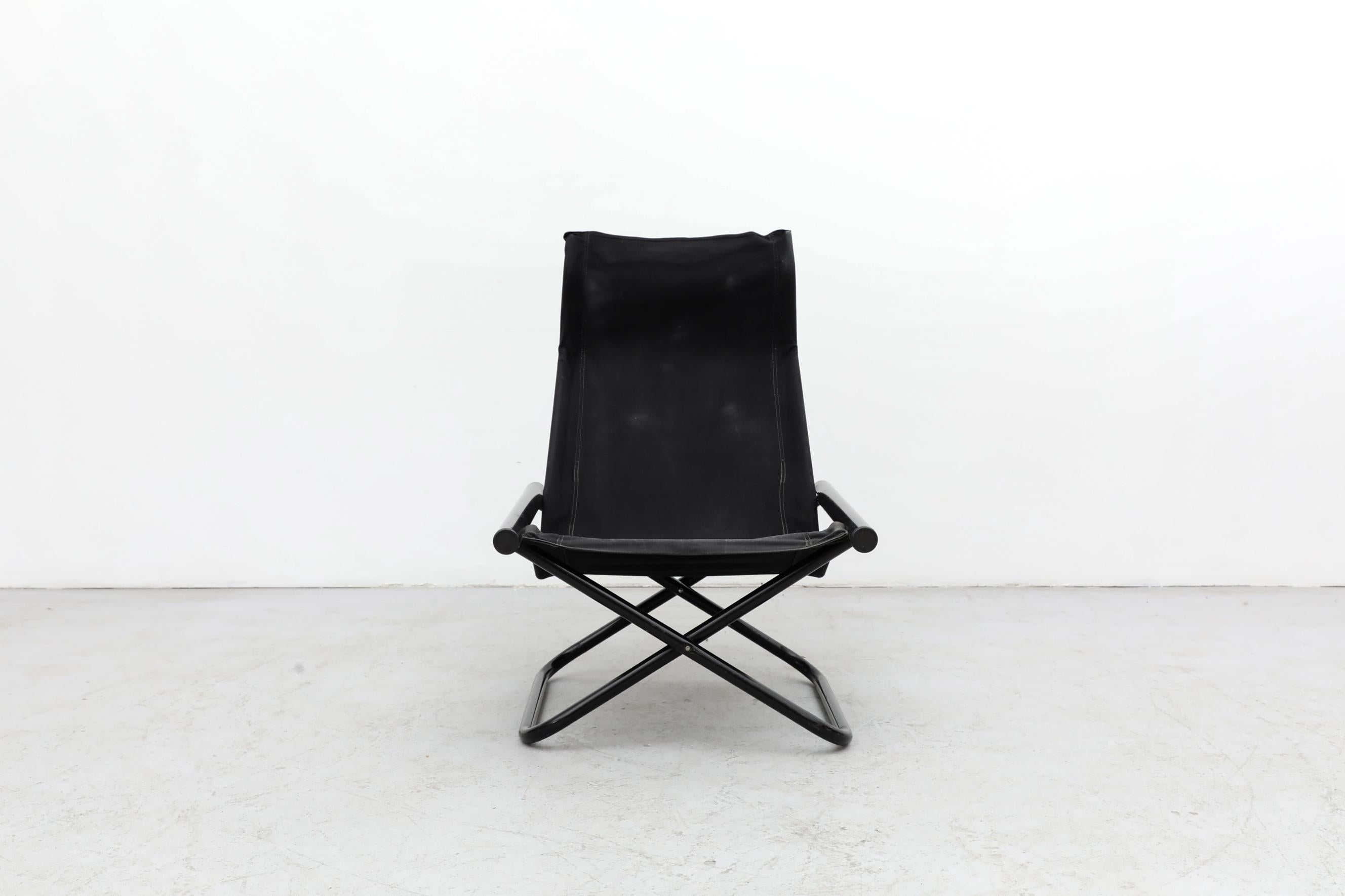 Inspired by the folding form of a traditional director's chair and the simplicity and materials of Danish modern design, this folding chair was designed by Japanese designer Takeshi Nii in 1958. It has round black lacquered armrests, a tubular frame