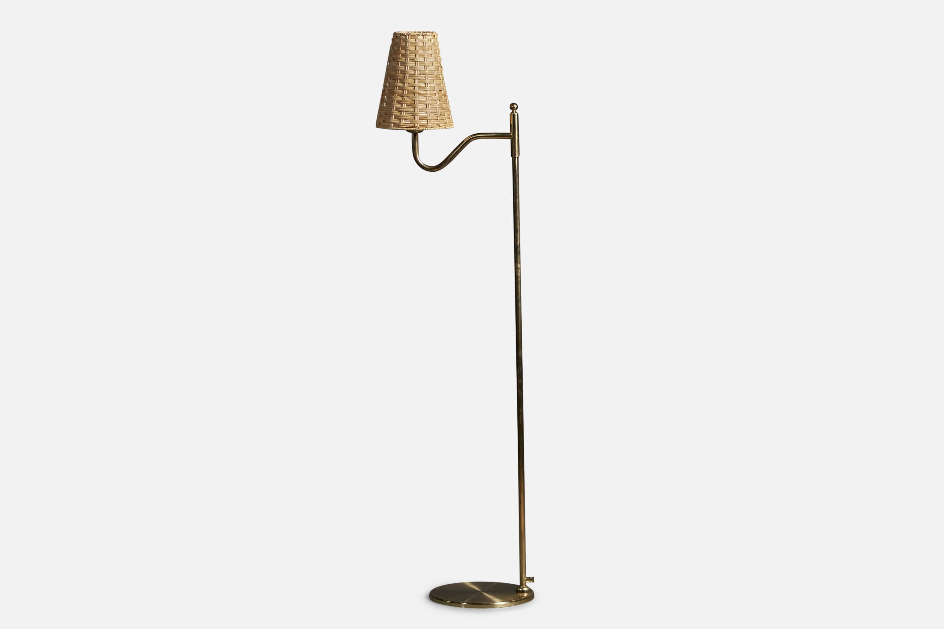 A brass and rattan floor lamp designed and produced by Nya Öia, Sweden, c. 1970s.

Overall Dimensions: 51.75