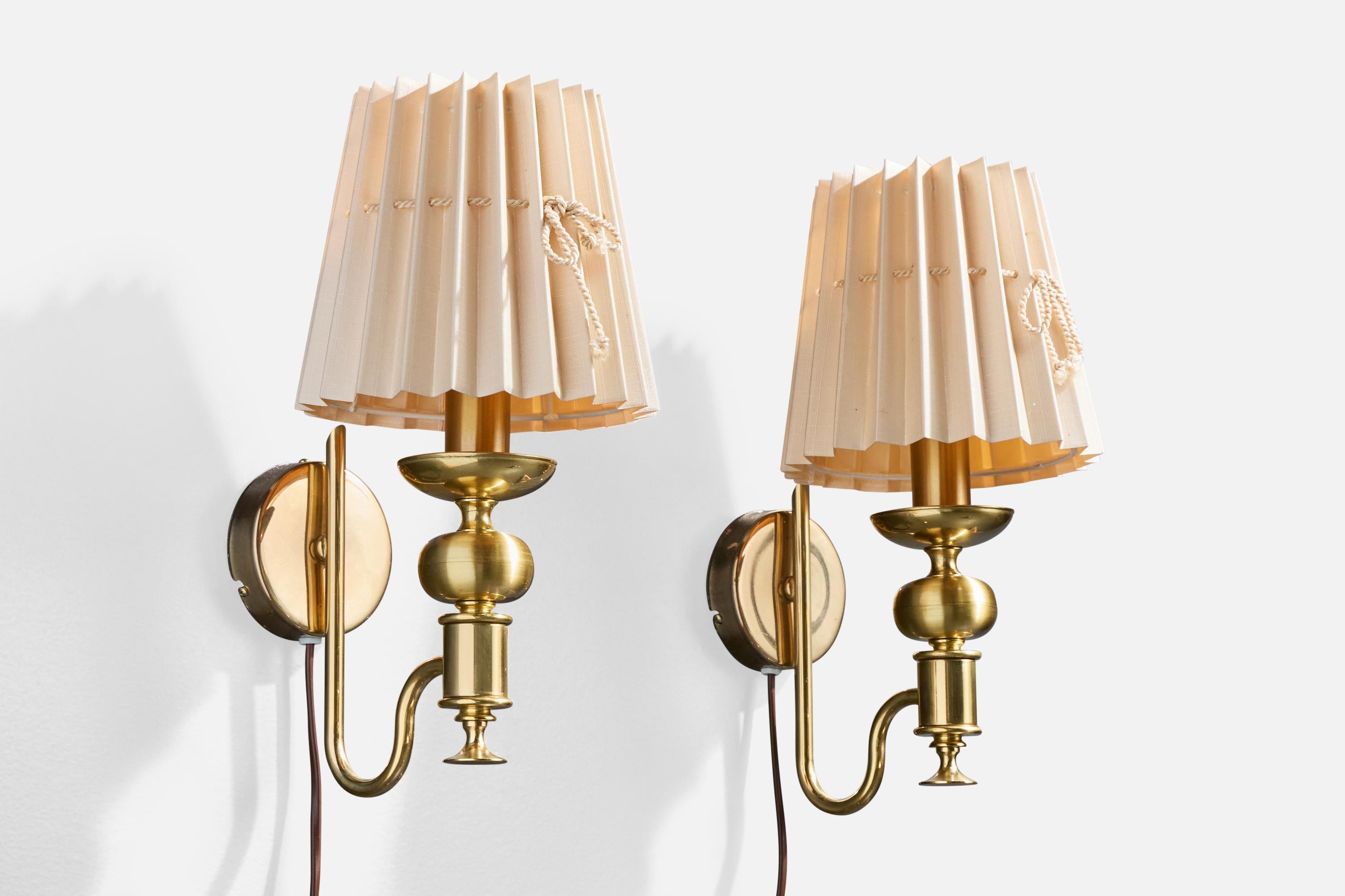 A pair of brass and light pink fabric wall lights produced by Nya Öia, Sweden, c. 1990s.

Overall Dimensions (Inches): 12.5