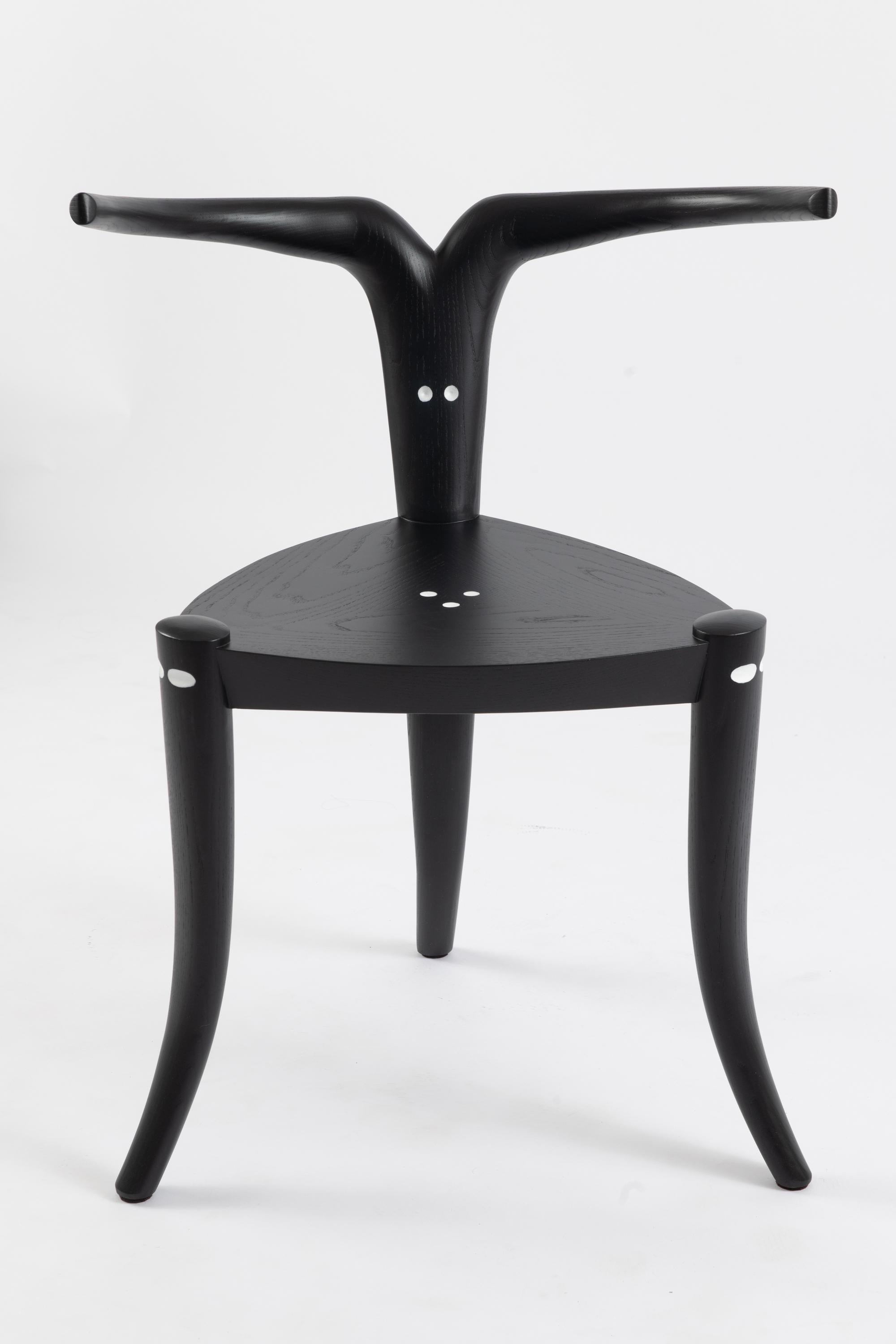 Jomo Tariku
Nyala Chair, 2022
Ebonized ash with carved and painted detail
Measures: 30 x 23.5 x 20 in
Edition of 18
 
Inspired by the shy and elusive mountain antelope from the Bale Mountains of East Africa, the hand-carved armrests and legs