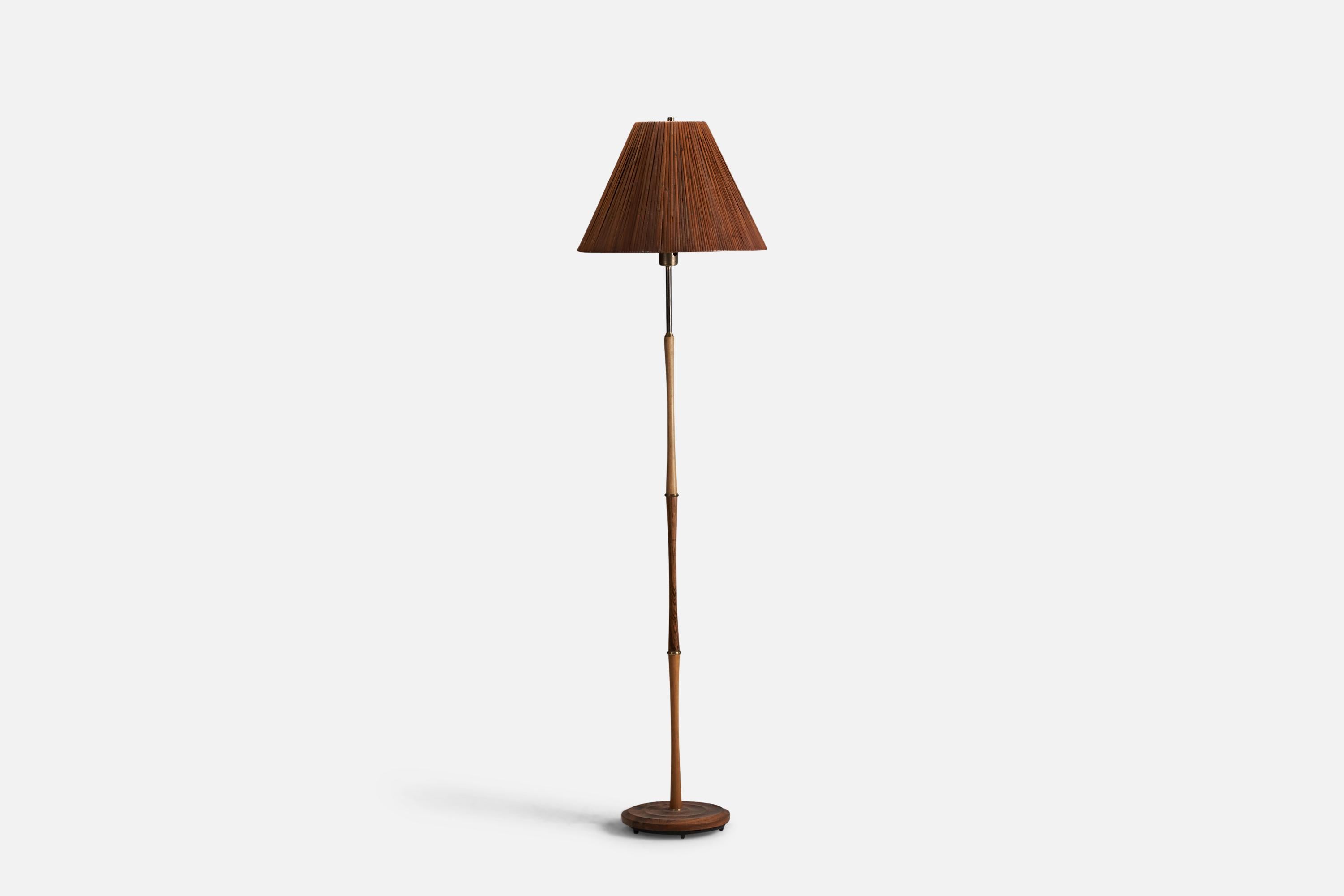 A rosewood, oak, teak, brass and rattan floor lamp designed and produced by Nybro Armaturfabrik, Sweden, 1950s.

Socket takes standard E-26 medium base bulb.

There is no maximum wattage stated on the fixture.