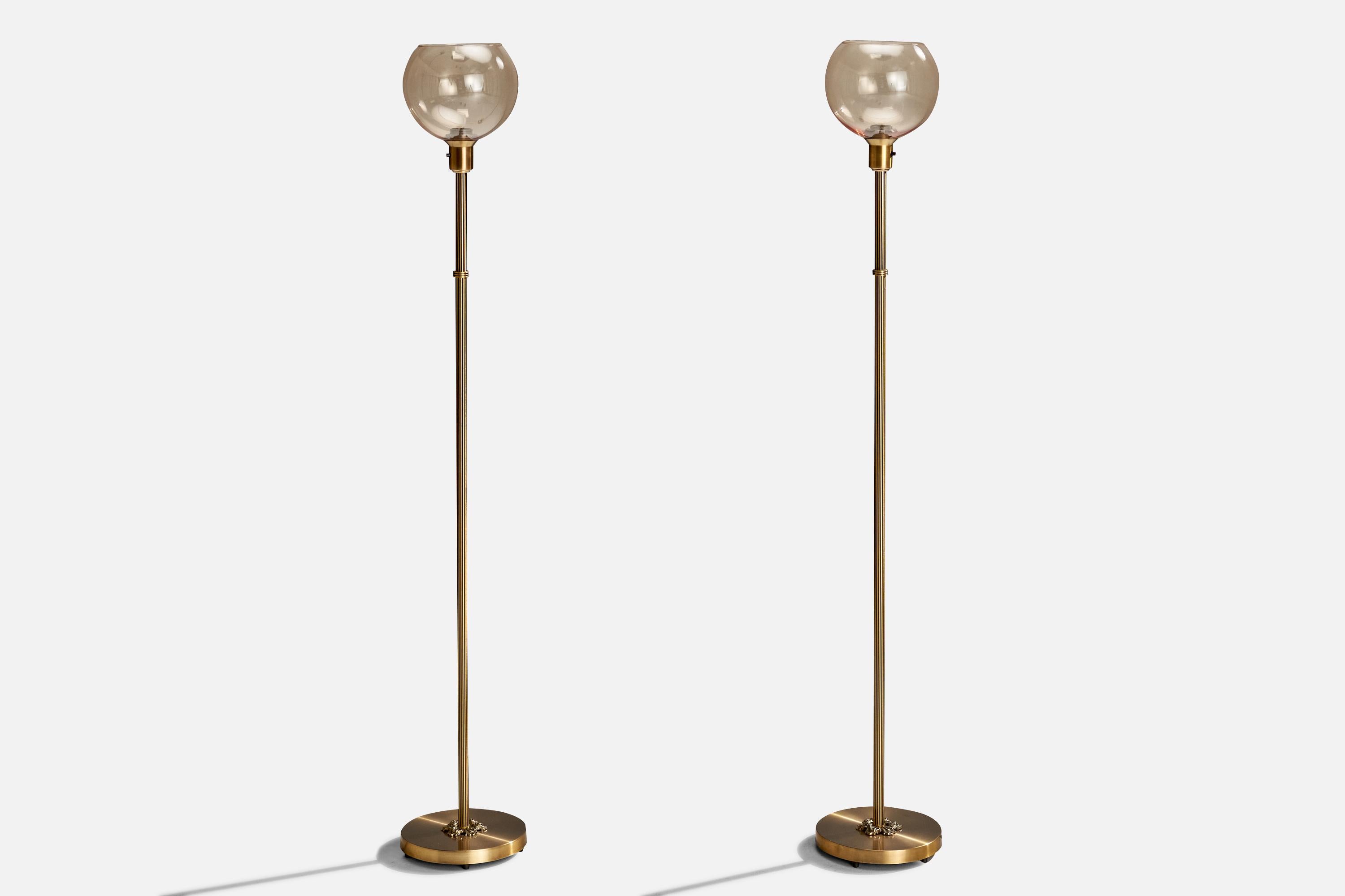 A pair of brass and smoked glass floor lamps produced by Nybro Armaturfabrik, Sweden, c. 1950s.

Dimensions of Lamp with Shade (inches): 55.375” H x 8.75” Diameter
Bulb Specifications: E-26 Bulbs
Number of Sockets (per fixture): 1
Sold with