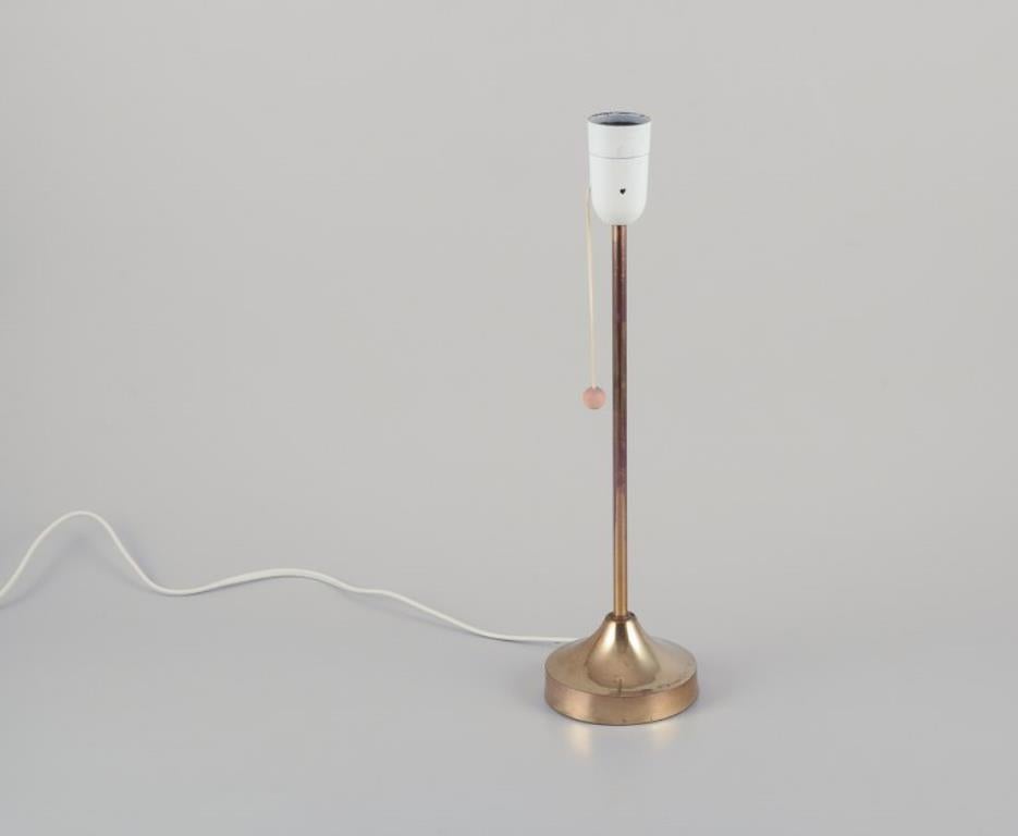 Nybro Armaturfabrik, Suède Lampe de table en laiton.
Design/One élégant avec interrupteur à bascule en bois.
Depuis les années 1970. 
En bon état avec une bonne patine.
Marqué.
Dimensions : 40,0 cm H x 10,5 cm L.