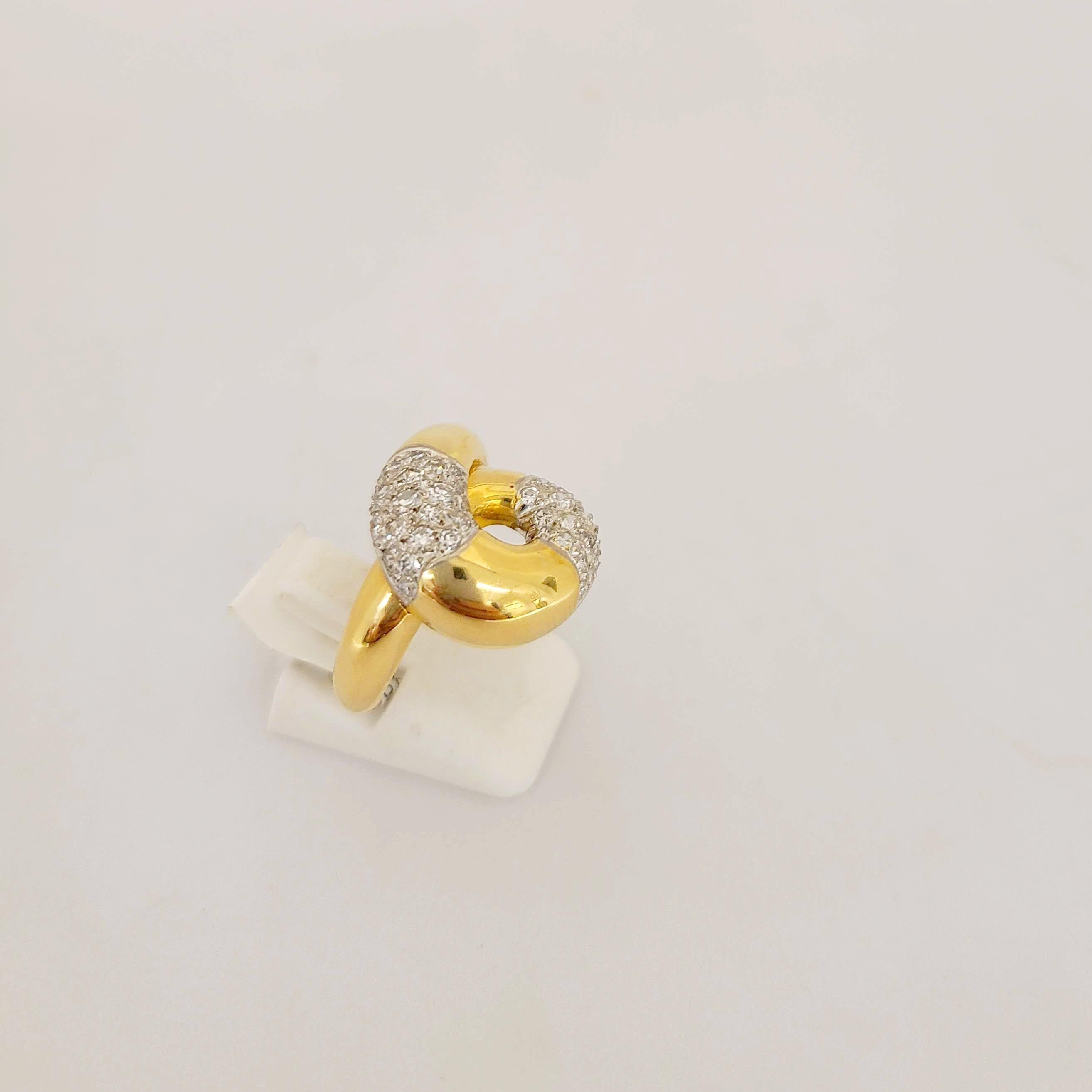 This 18 karat yellow gold ring is designed with a high polished swirl set with 0.80 carats of diamonds.
Ring size 7 3/4   sizing options are available.
