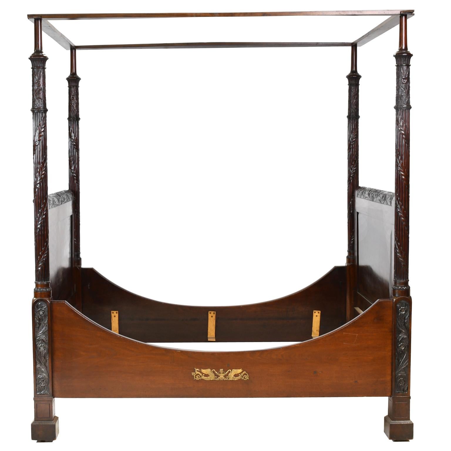 An exceptional American Federal sleigh bed with tester in fine West Indies/ Cuban mahogany with beautifully-articulated floral and acanthus-leaf carvings, along the crest of the headboard and footboard, and on the four posts, attributable to the