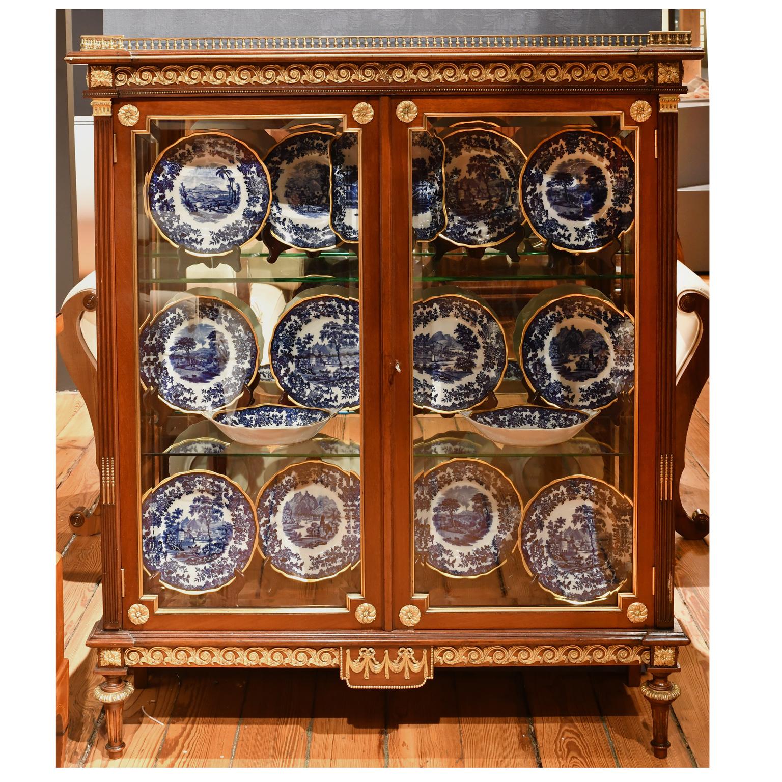 From the Gilded Age, a very beautiful New York City vitrine in the Louis XVI style, attributable to Leon Marcotte, in mahogany with Fine brass ormolu mounts and gallery, beveled glass on front and side panels, and two adjustable glass shelves, circa