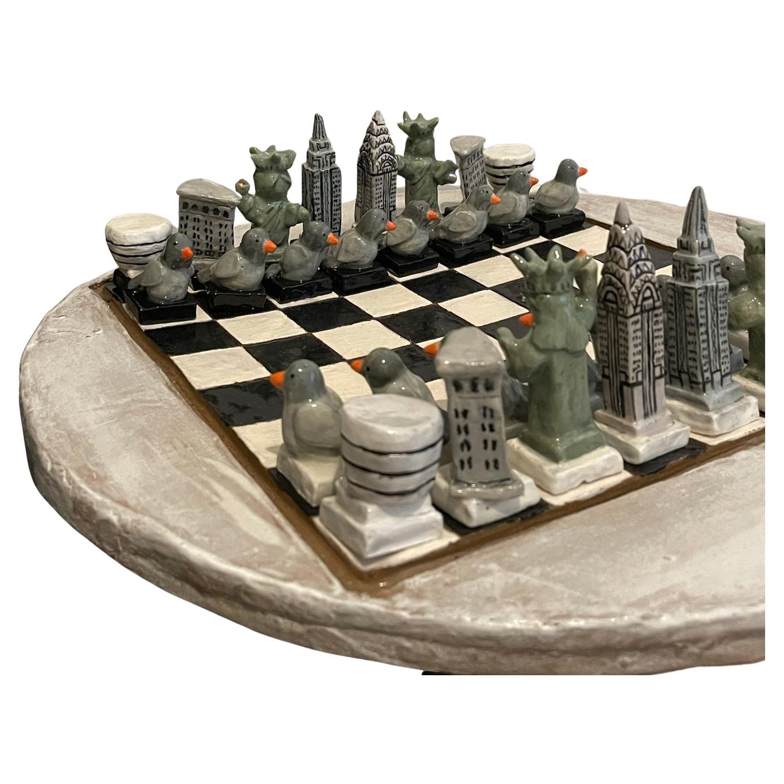 Introducing the NYC Skyline Chess Set: a finely crafted homage to the city that never sleeps. Each of the 32 ceramic pieces is unique and meticulously handcrafted from clay and glazed for a polished finish. 

In this set, Manhattan's icons represent