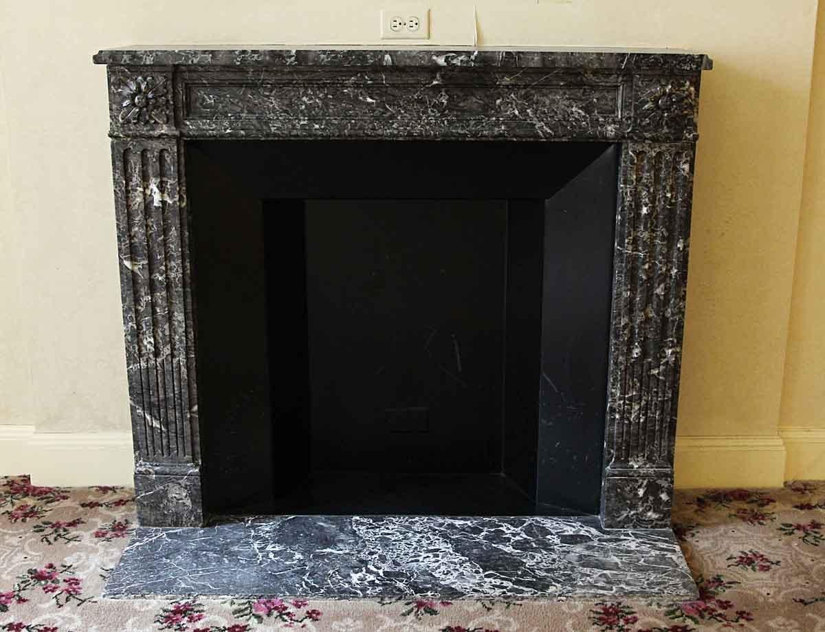 Hearth not included. From the 1931 NYC Waldorf Astoria Hotel. 1880s dark gray with white veining marble mantel done in a French Regency style. This mantel was one of a group of antique mantels imported from Europe and installed in the Waldorf