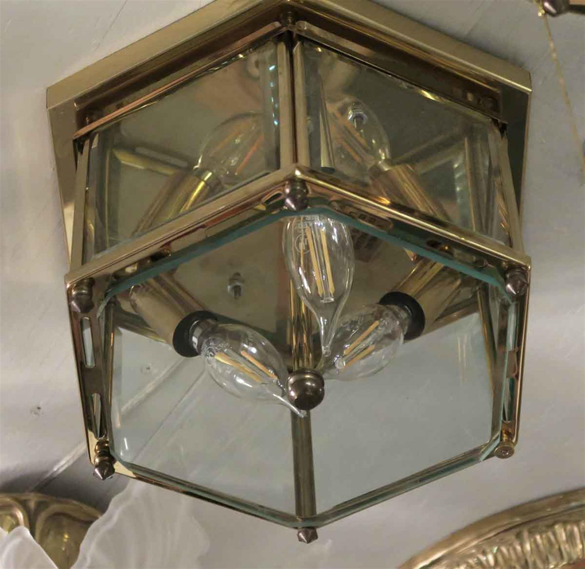 Petite small hexagon shaped flush mount light made from brass and beveled glass. These lights adorned various corridors of the towers of the NYC Waldorf Astoria Hotel. Takes three candelabra bulbs. Waldorf Astoria authenticity card included with