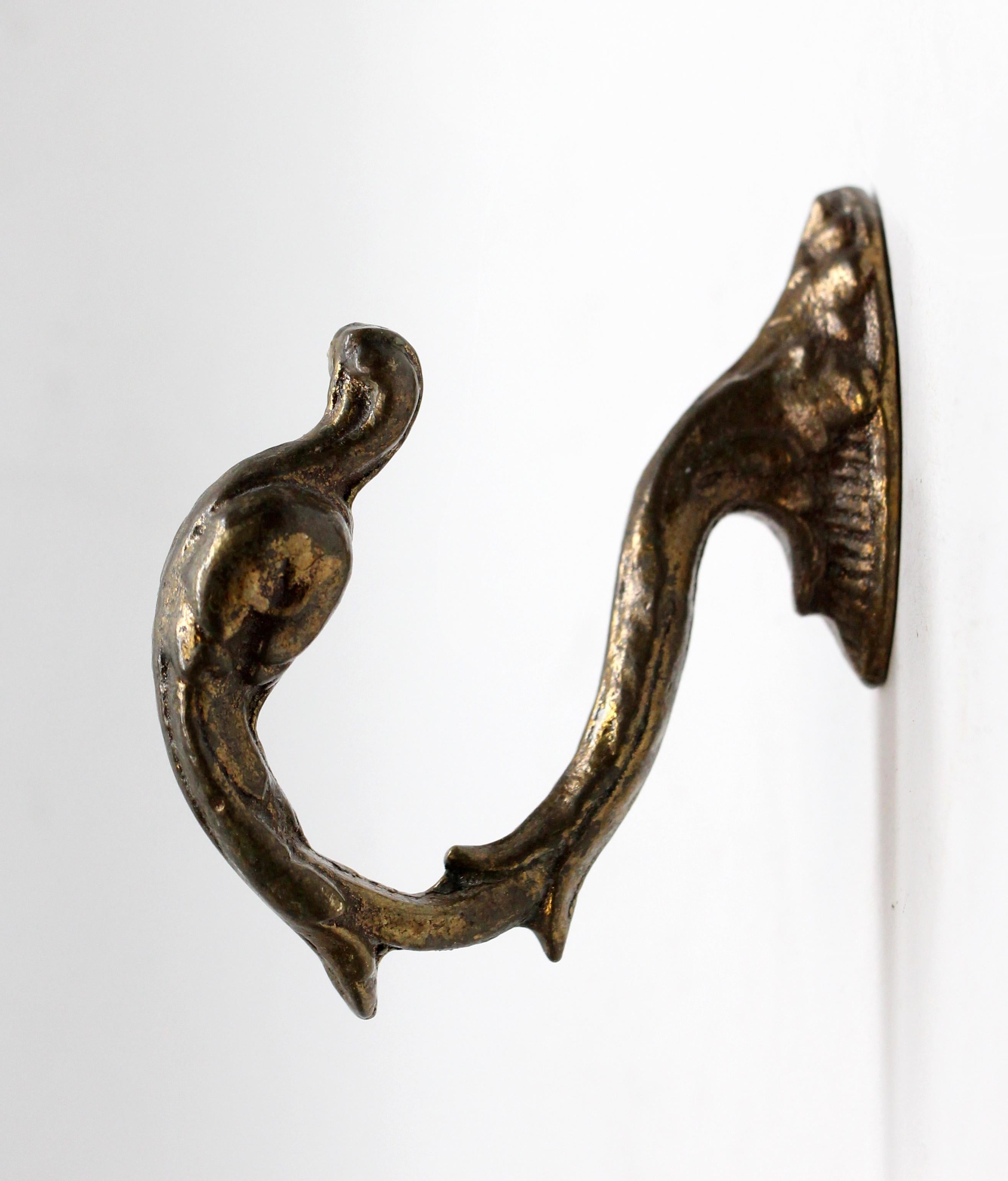 Mid-20th Century bronze curtain tie back or hook in the shape of a swan. From the famous Waldorf Astoria in New York City on Park Ave in Manhattan. Takes one hanger bolt to install (not included ). Waldorf Astoria authenticity card included with