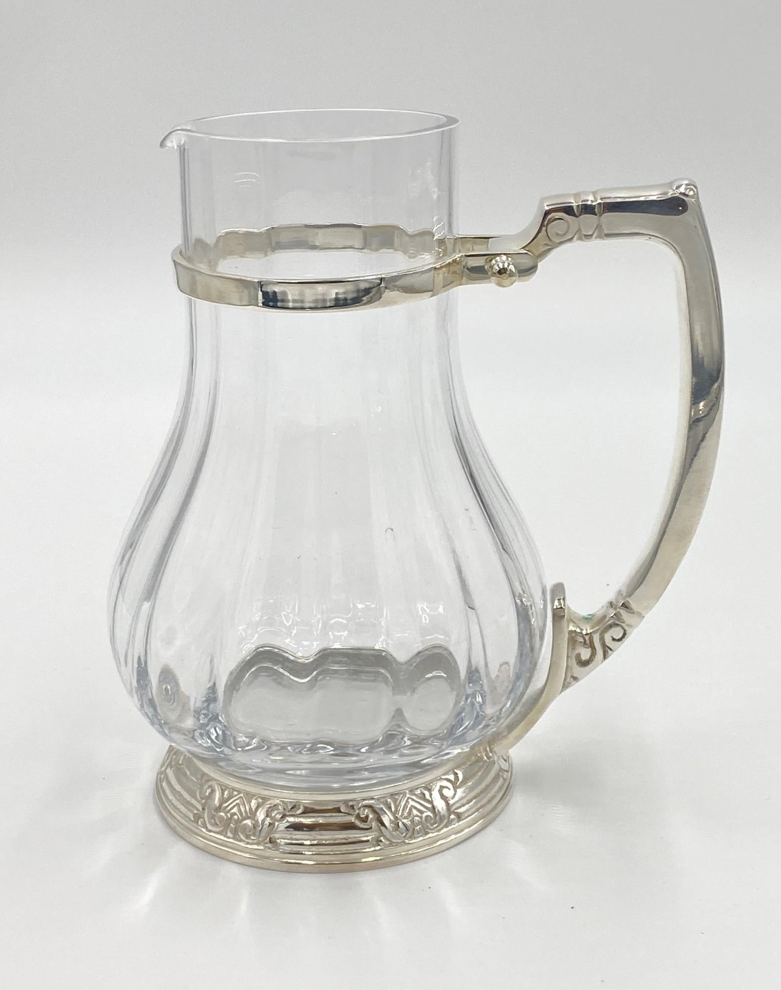 From the NYC Waldorf Astoria Hotel on Park Ave. Never used 20th century old new stock. Clear glass pitcher with the original Waldorf Astoria Art Deco styling on the silver plated frame and handle. Made by D.W. Haber and Sons. Small quantity