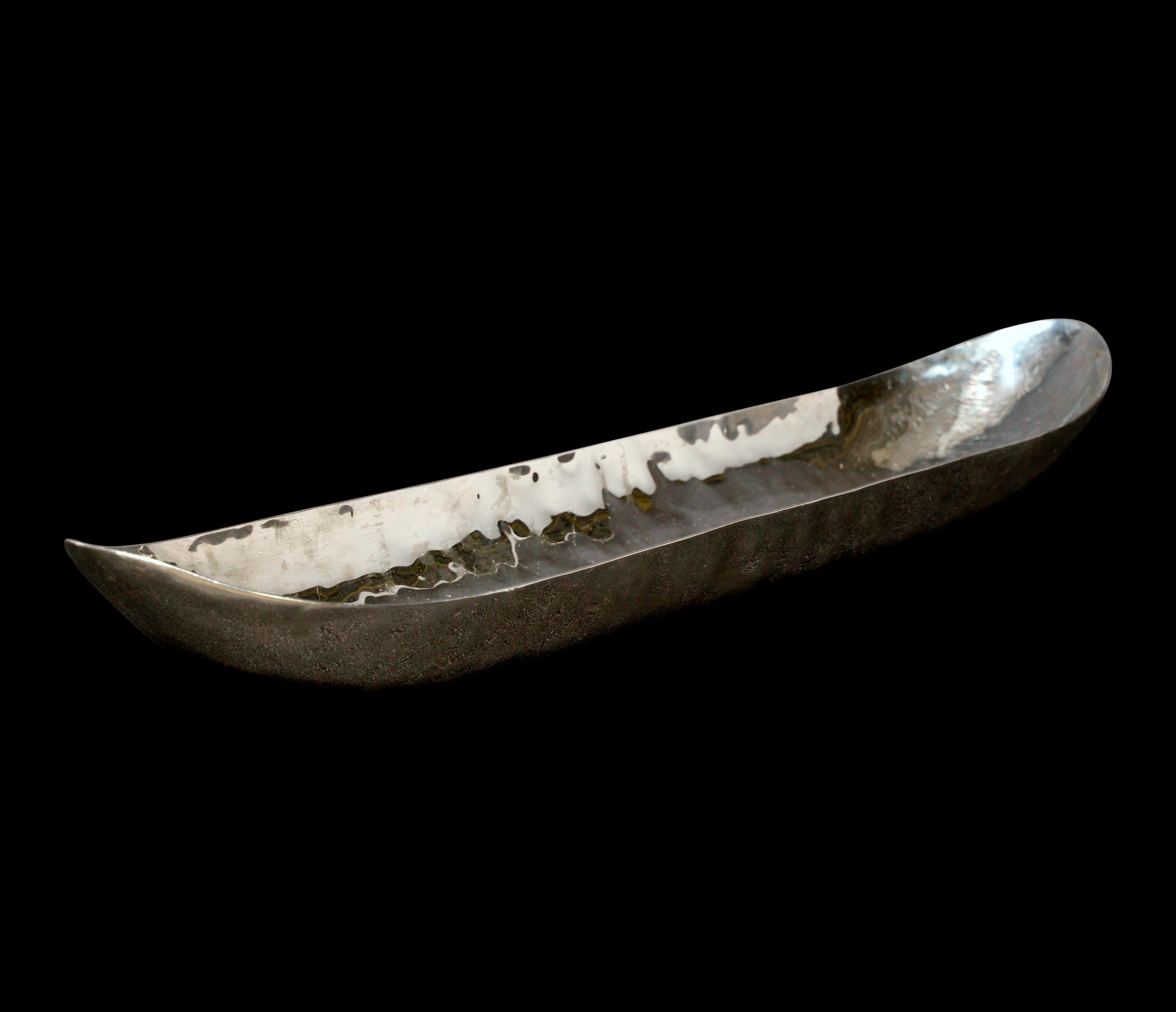Retrieved from one of the NYC Waldorf Astoria's many unique restaurants. This is an elongagated stainless steel serving dish featuring a hammered texture. Manufactured by Zieher. Zieher produces luxury tabletop and buffet accessories for 5 star