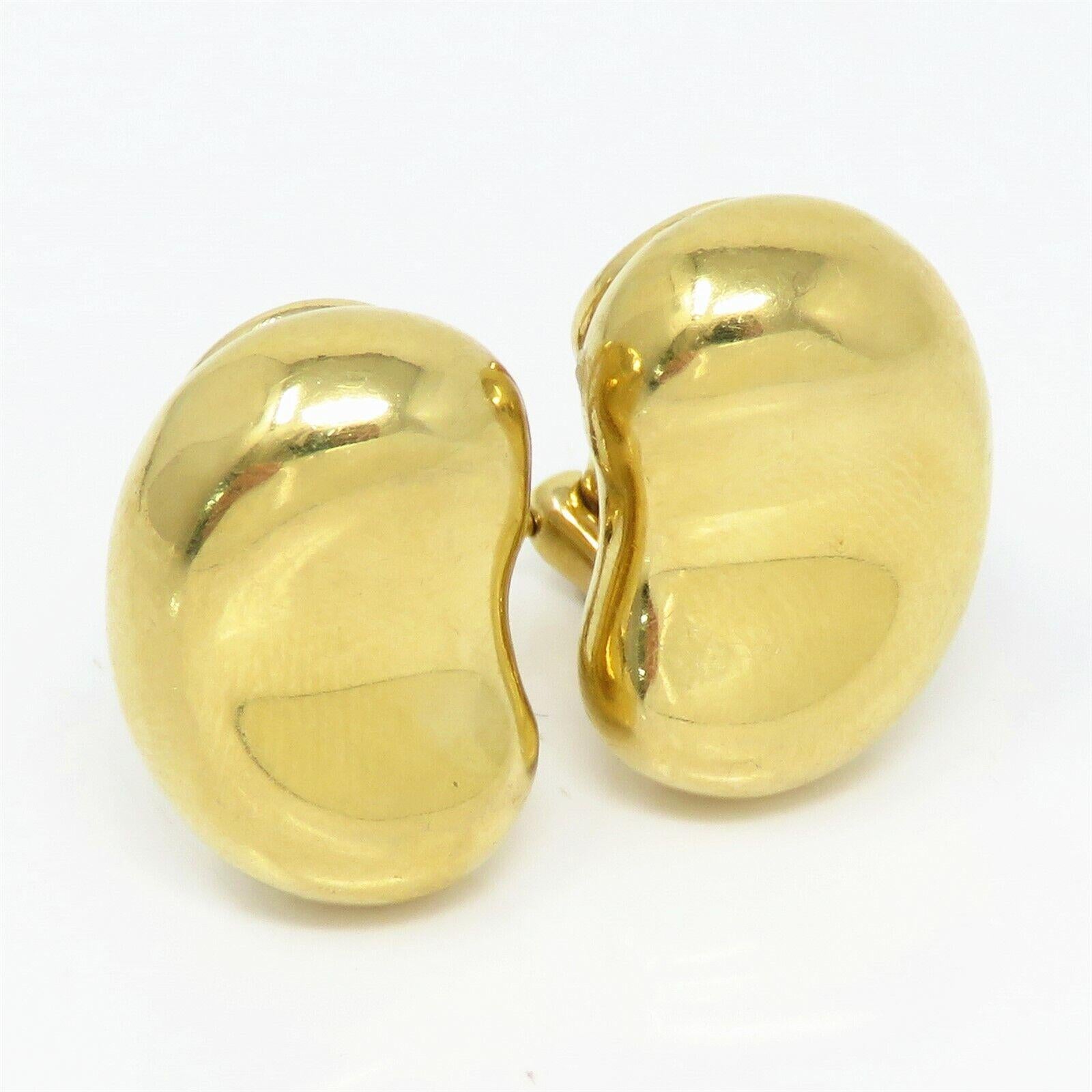 These elegant Tiffany & Co. Elsa Peretti Bean Clip Earrings are crafted from luxurious 18K yellow gold. Designed in a large size, the iconic bean shape symbolizes the origin of all things and is a hallmark of Peretti's organic aesthetic. The smooth,