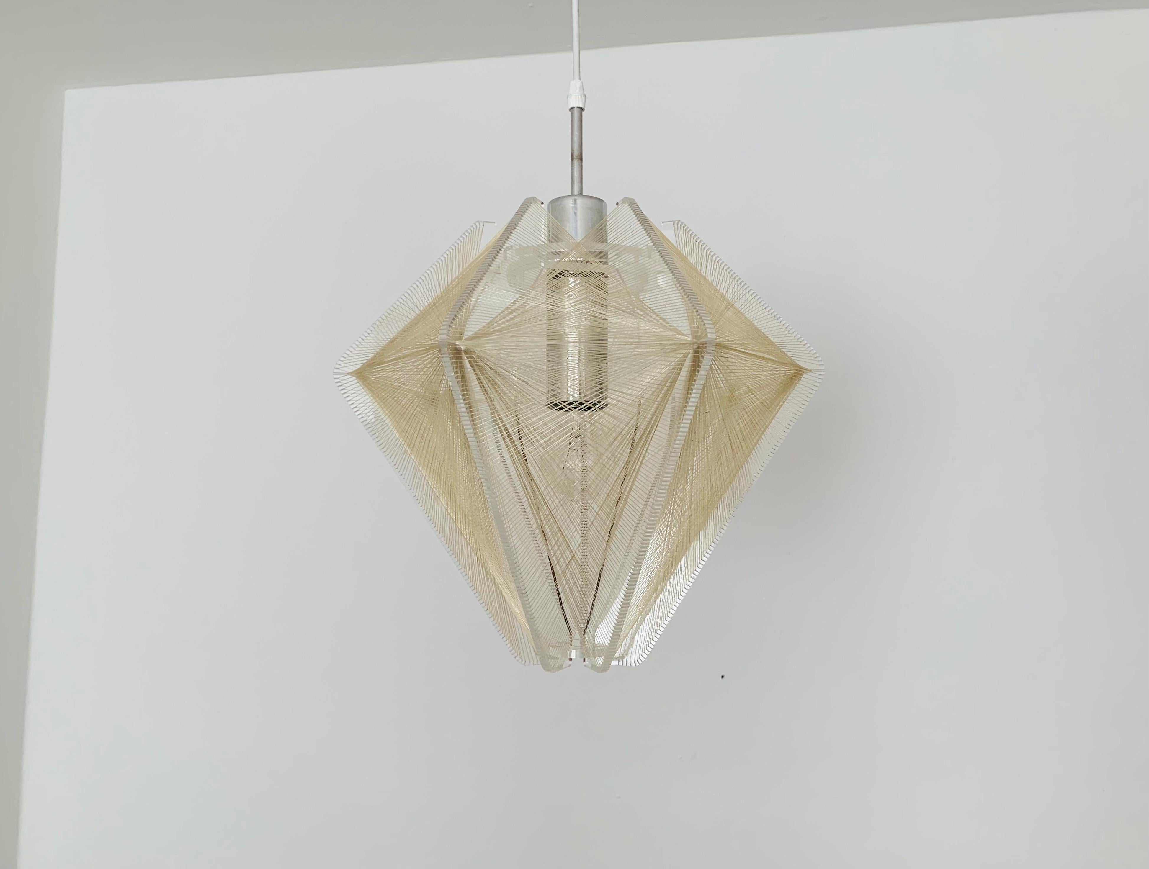 Very rare acrylic pendant lamp from the 1960s.
Exciting design and great workmanship.
The nylon threads create a very nice light atmosphere.

Design: Paul Second
Manufacturer: Sompex

Condition:

Very good vintage condition with slight