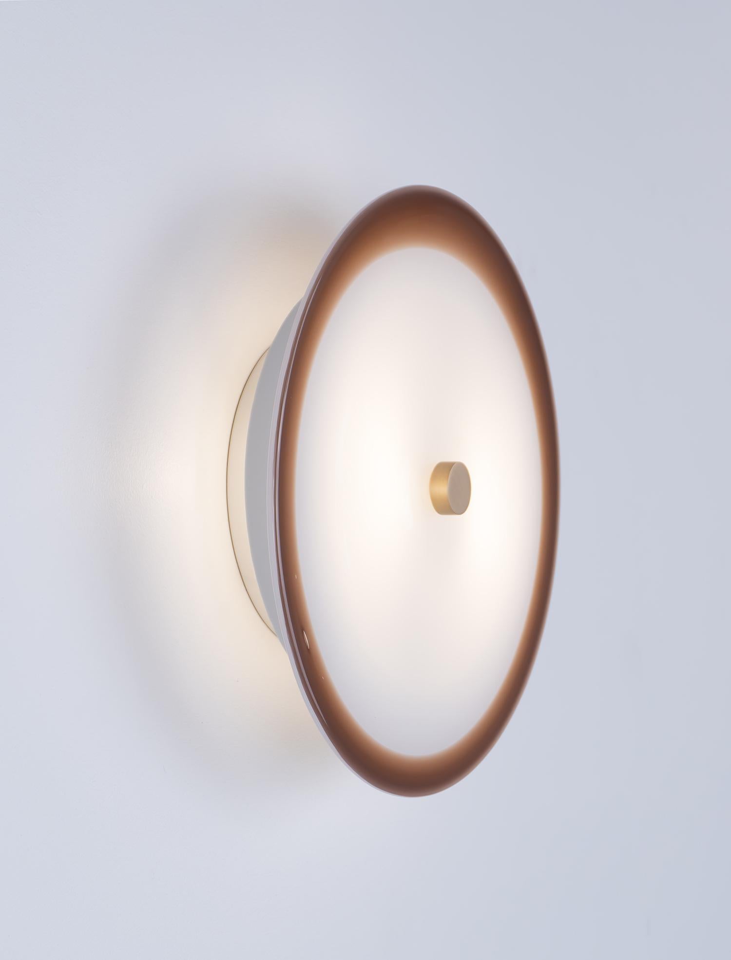 The Nymphaea Sconce is created from one or two colors of handblown glass with brass hardware. The Nymphaea Collection evokes the delicate dance of colorful blossoms amid the tranquility of floating lily pads. 

Select a single glass color (see