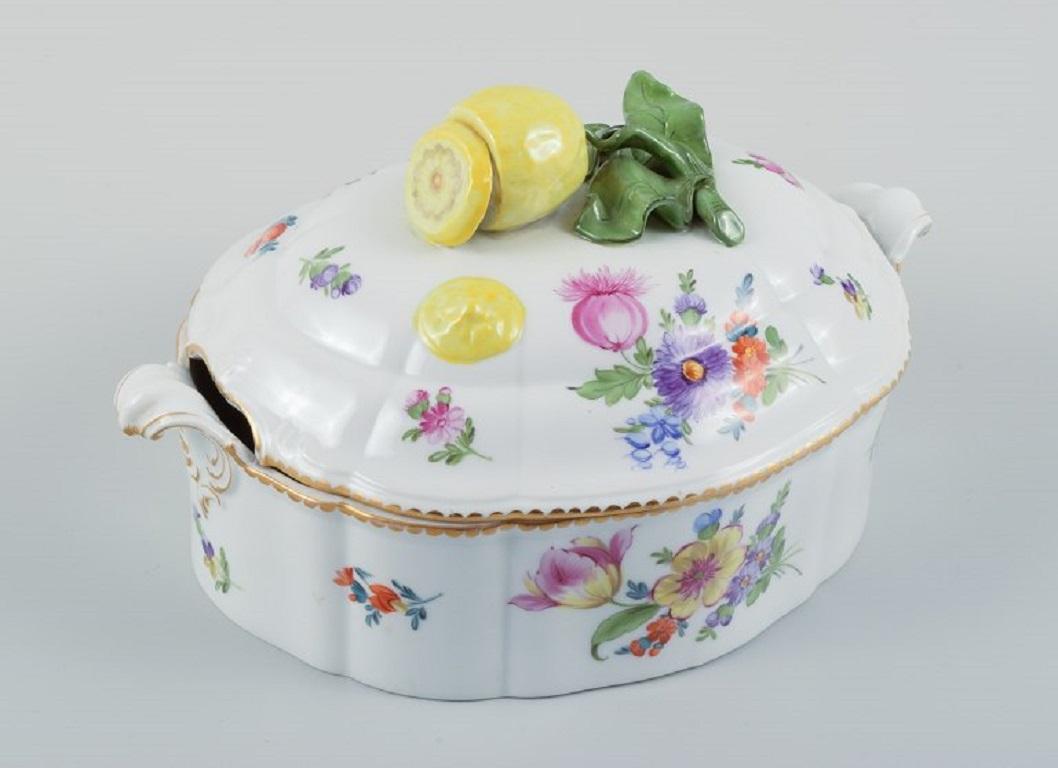 Nymphenburg, Deutschland. Handbemalte Porzellan-Deckelterrine mit polychromen Blumen, Deckelknauf in Form einer Zitrone.
Ca. 1930er Jahre.
In ausgezeichnetem Zustand.
Gekennzeichnet mit Nymphenburg.
Abmessungen: L (einschließlich Griff) 27,0 cm. x H