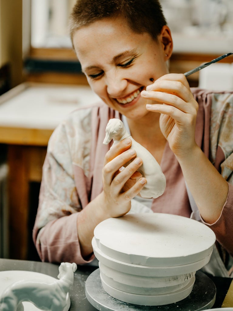 Nymphenburg Porcelain handcrafted and hand painted cherub on a pedestal For  Sale at 1stDibs, image size:768x1024