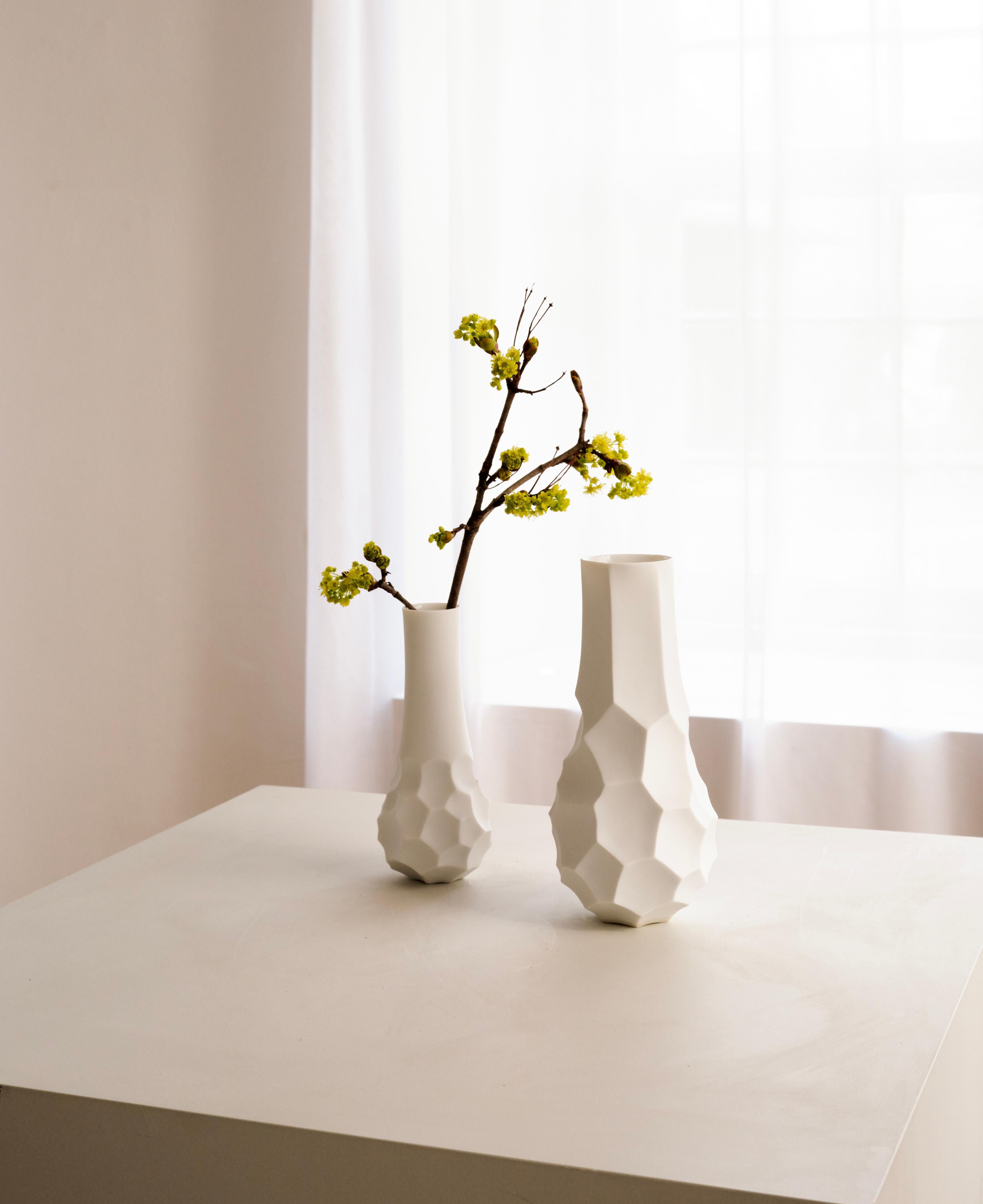 This is a pair of porcelain vases designed by Ted Muehling for Porzellan Manufaktur Nymphenburg. This pair consists of one vase small and one vase medium - please refer to the two images of single vases in our publication. They are white bisque
