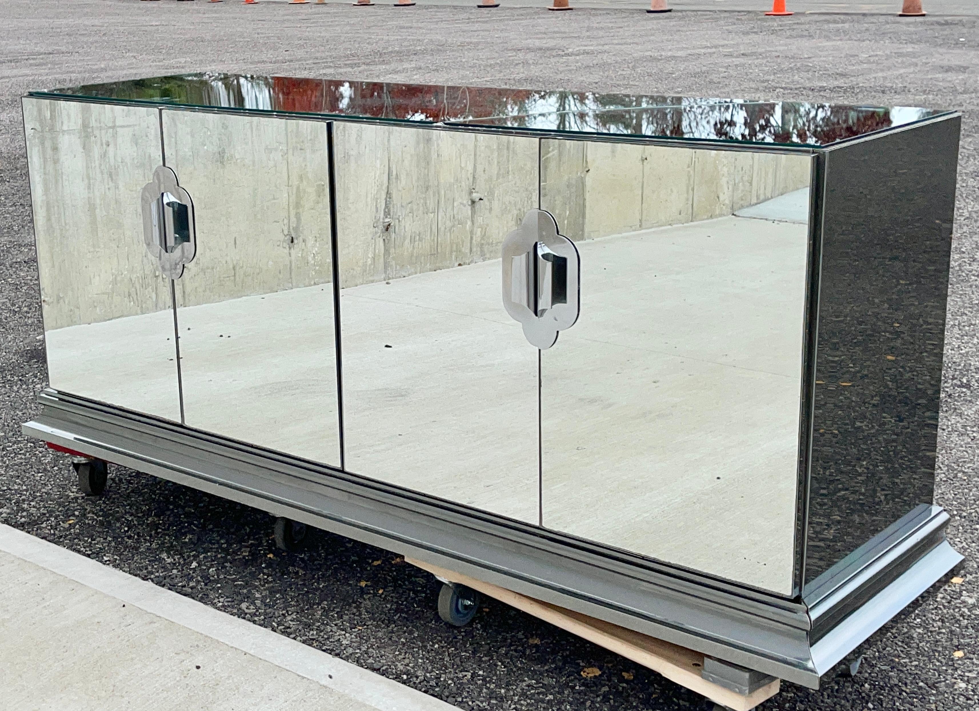 Luxuriously well constructed mirrored sideboard cabinet on heavy molded chrome base produced by Ello Furniture Manufacturing Co. in the late 1970s and designed by O. B. Solie. Materials used are mirror-polished stainless steel and laminated mirrored