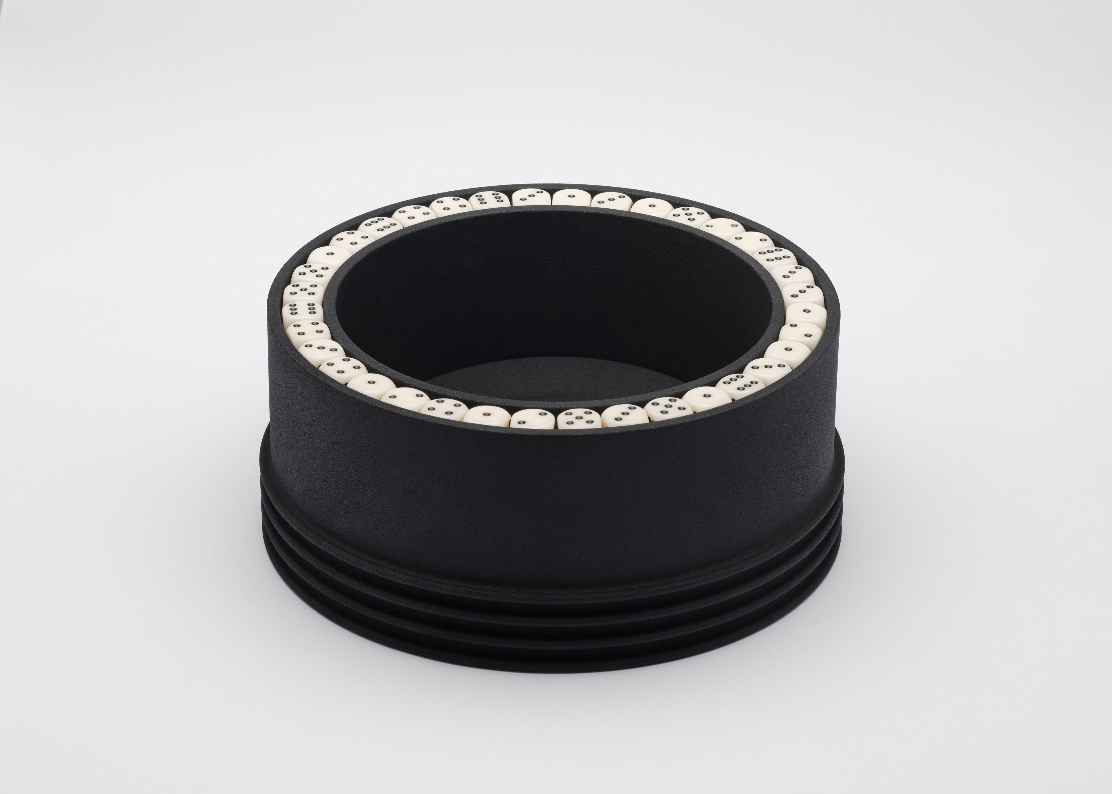 Known as the O-bowl, this contemporary 3D printed satin black PA12 Nylon bowl decorated with dice is a great decorative bowl and centrepiece that can also be used as a gaming tray.
This intricate object of unique design by Alexandre Arrechea was