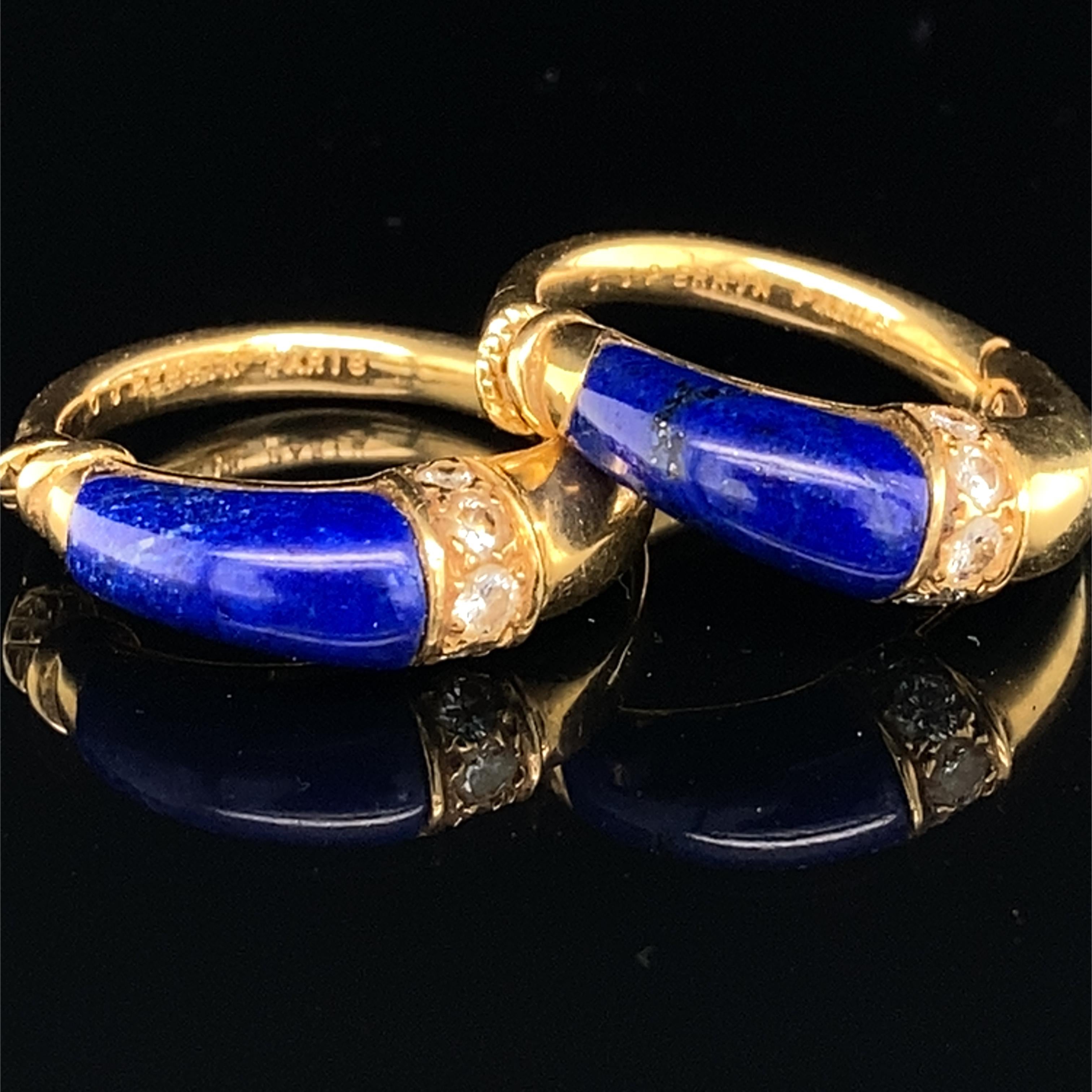 A fine pair of O. J. Perrin lapis lazuli, diamond and 18K gold hoop earrings,
made by André Vassort, 
ca. 1970s/80s,
the front of each hoop adorned with vividly blue, polished lapis lazuli and five small brilliant cut diamonds, 
fitted as clip-on