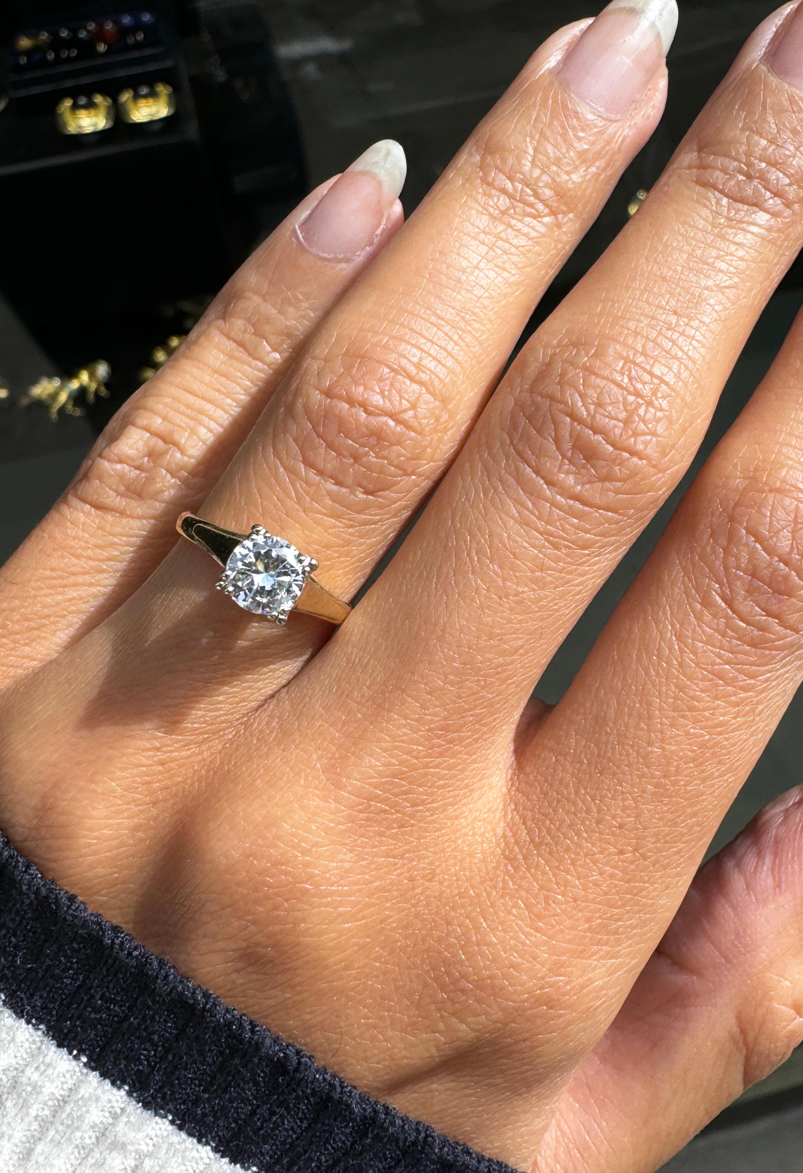 This striking solitaire diamond ring exudes mid-century glamour. 

This charming ring boasts a wonderful 0.69 cat transitional cut diamond, exquisitely held in place by four 18 carat white gold tri-split claws in a delicate, open back setting.

With