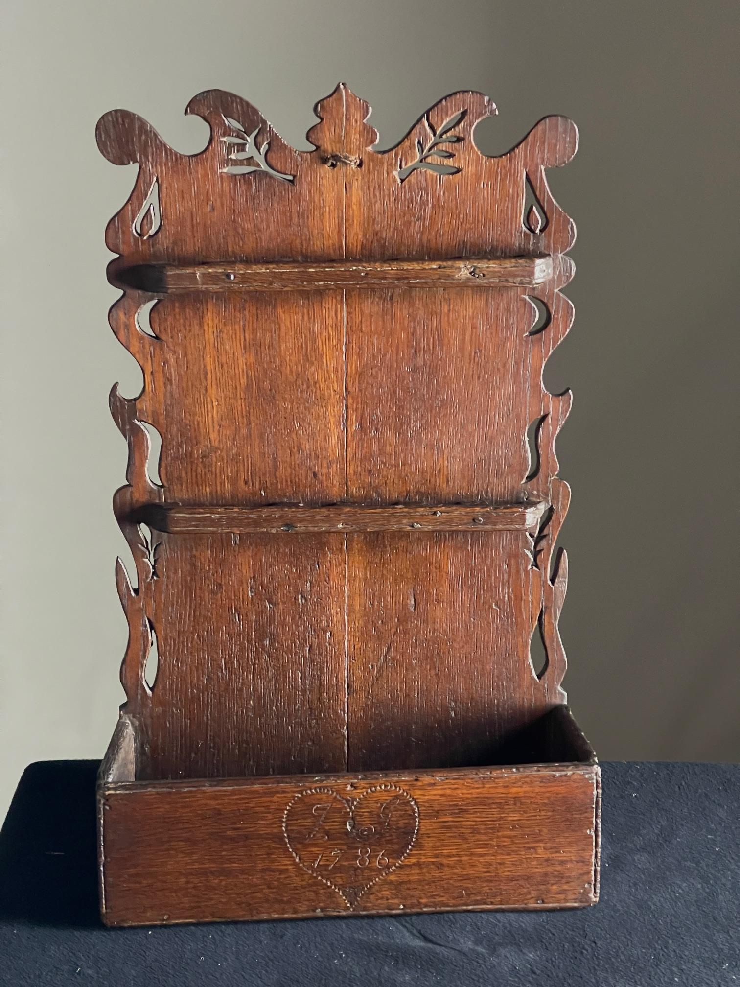 Oak 18th Century spoon rack

Dated 1786 oak spoon rack with shaped sides and interesting piercings.

Dimensions 64 cms high 38cms wide 14cms deep