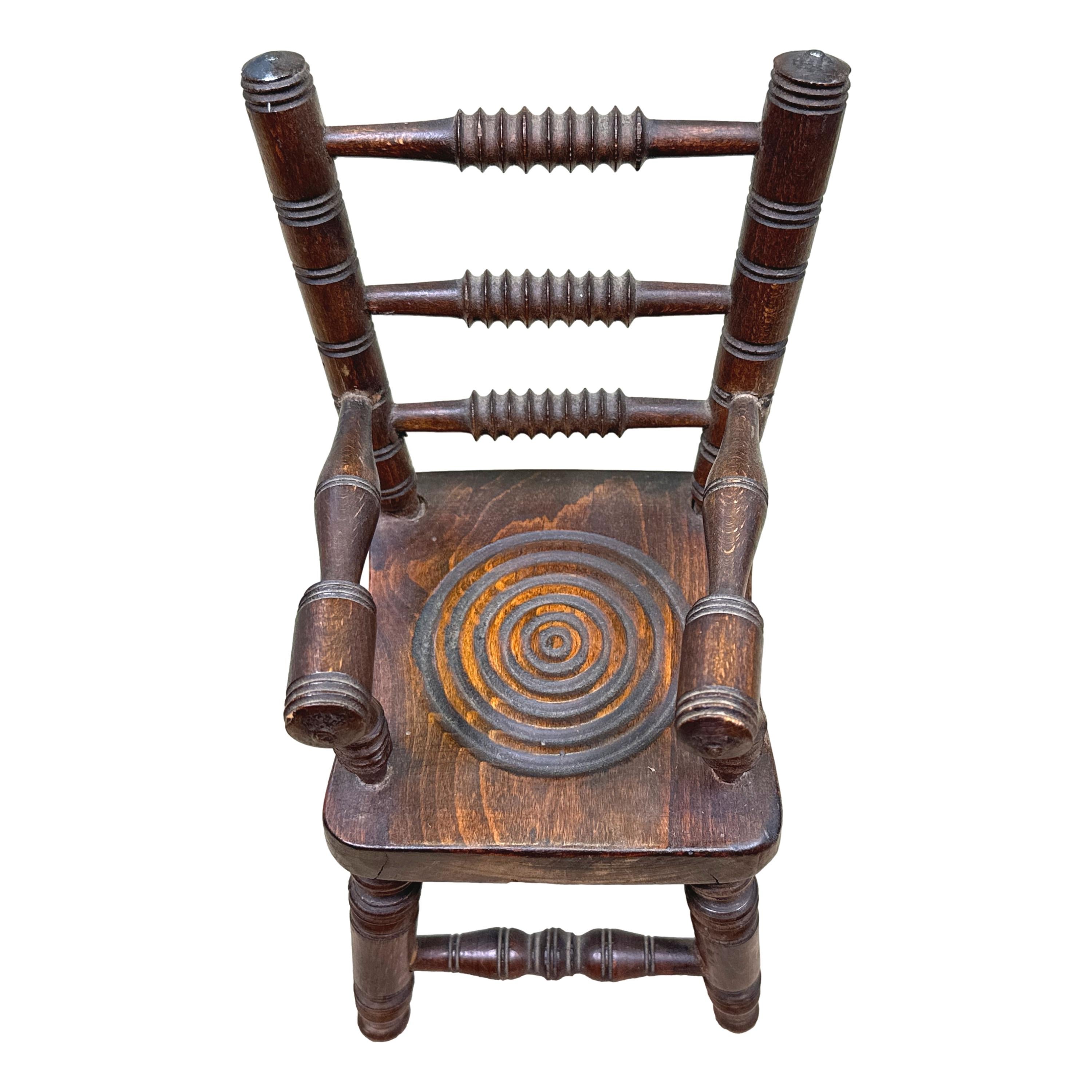 An Extremely Rare And Very Attractive Late 19th Century Oak Miniature Kitchen Windsor Armchair, Having Attractive Turned Decoration To Back And Seat, With Elegant Turned Arms, Legs And Stretchers.

A most unusual and charming item of miniature