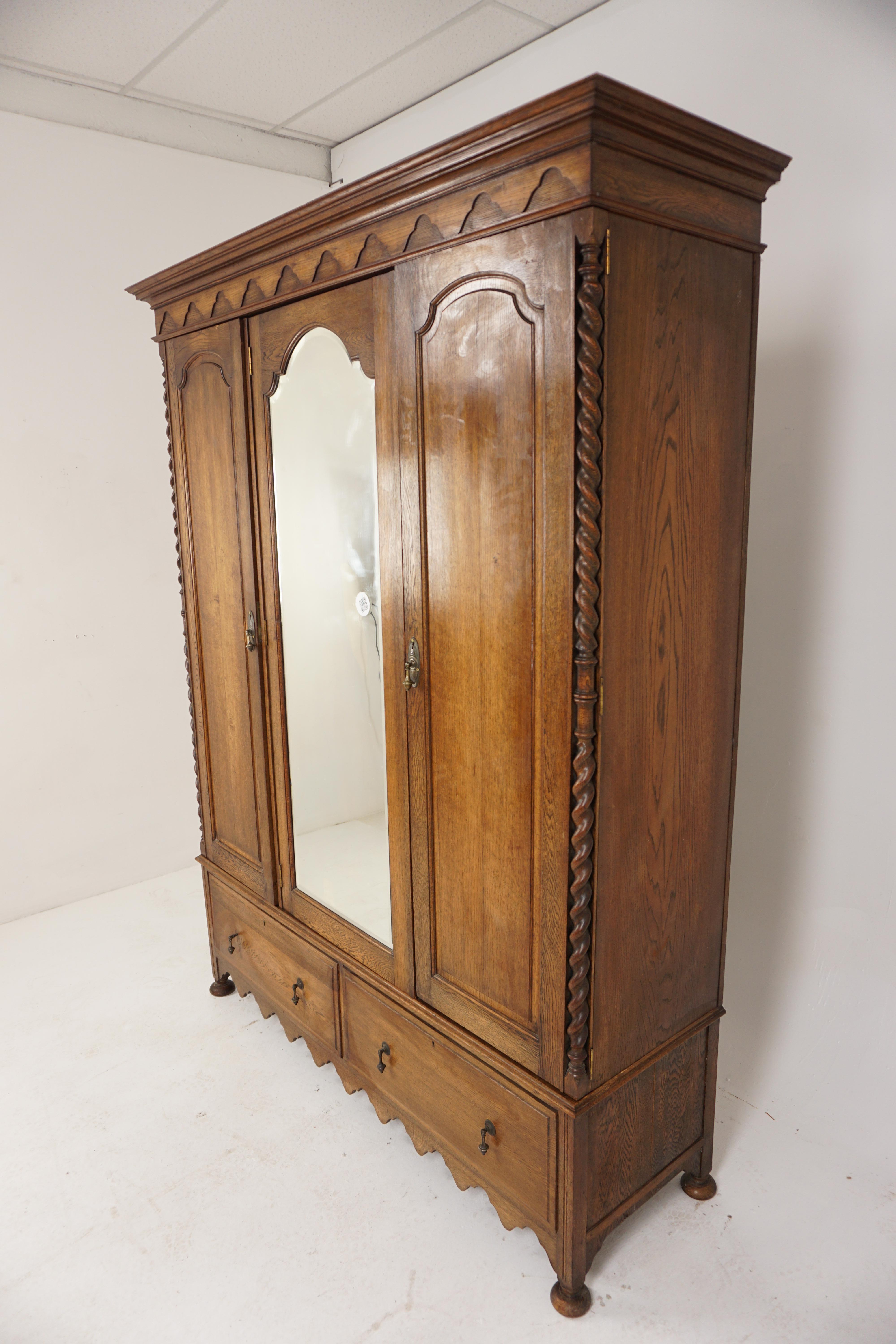 
Antique Oak 3 Door Barley Twist Armoire, Wardrobe Closet, Bevelled Mirror, Scotland 1910, H784

Scotland 1910
Solid Oak
Original Finish
Large overhanging cornice on top
Wavy shaped frieze below
Single shaped bevelled mirror door
Flanked by