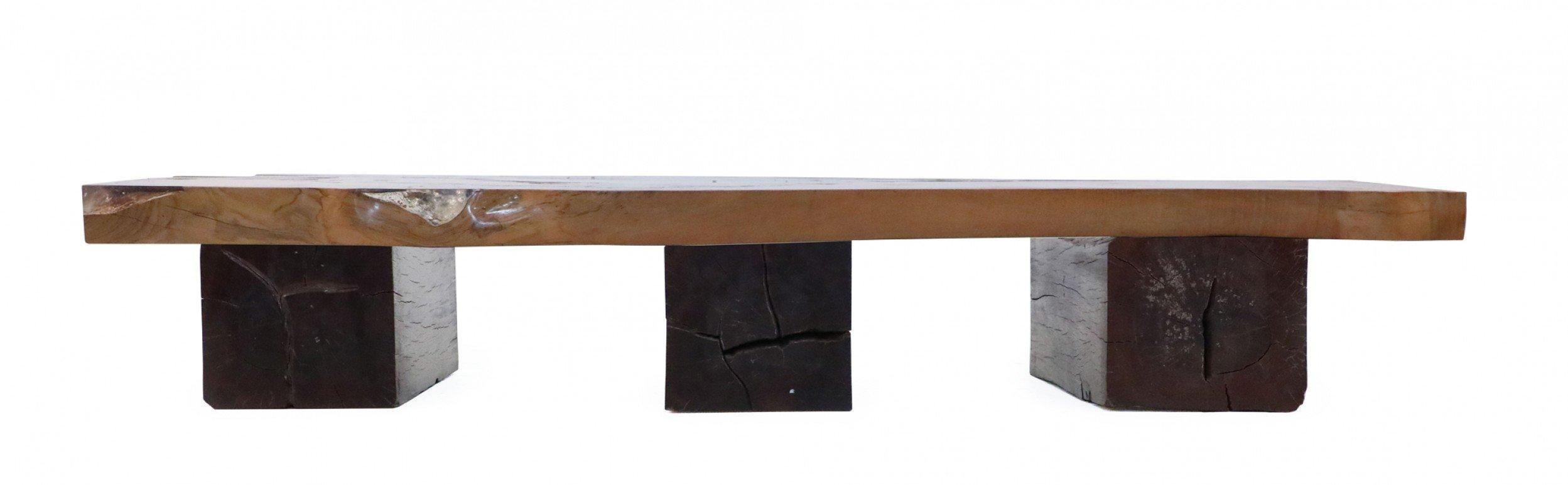 Contemporary live edge oak slab coffee table with poured amethyst resin in knot holes. Slab rests on three solid wood rectangular legs.