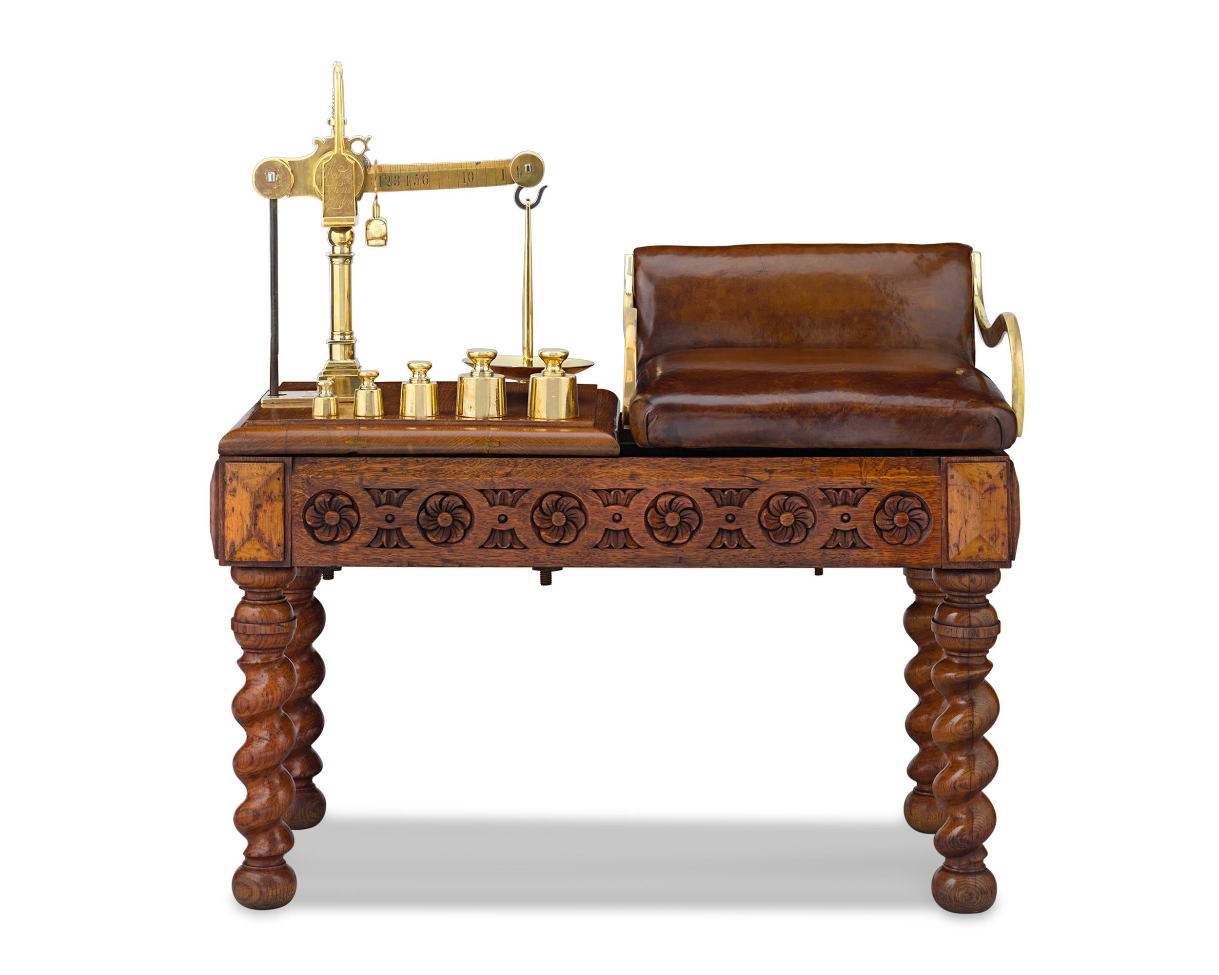This handsome English solid oak jockey scale retains its original upholstery and five brass weights by Young & Son. These beautiful scales were used at English tracks to determine the jockey’s weight before a big race. This was done to prevent any