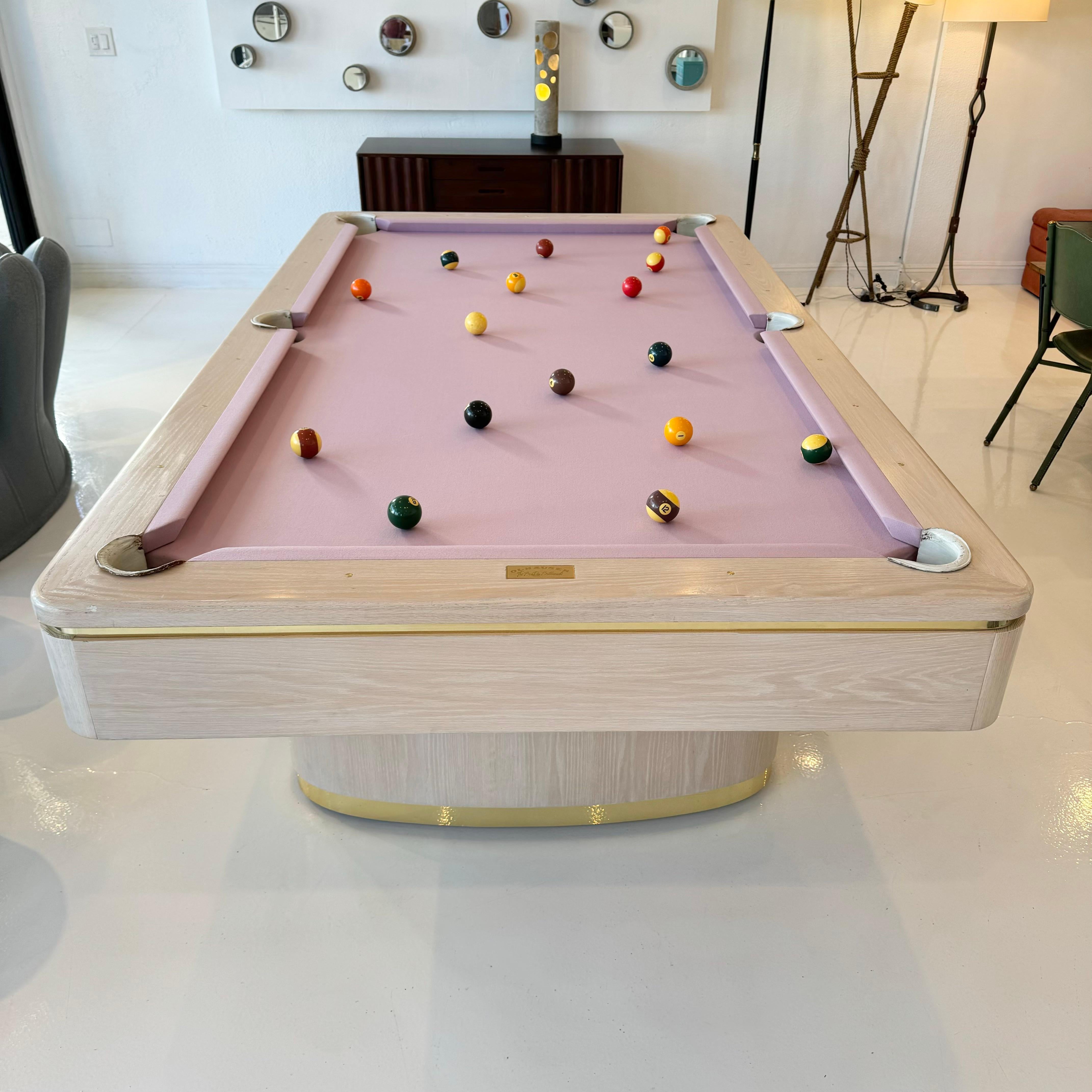 Wonderfull oak pool table handmade by Olhausen Billiards, the worlds largest manufacturer of pool tables. 

Rounded edge playing surface sitting atop two ovular pedestal bases. Very good condition throughout with slight wear as shown. Brass style