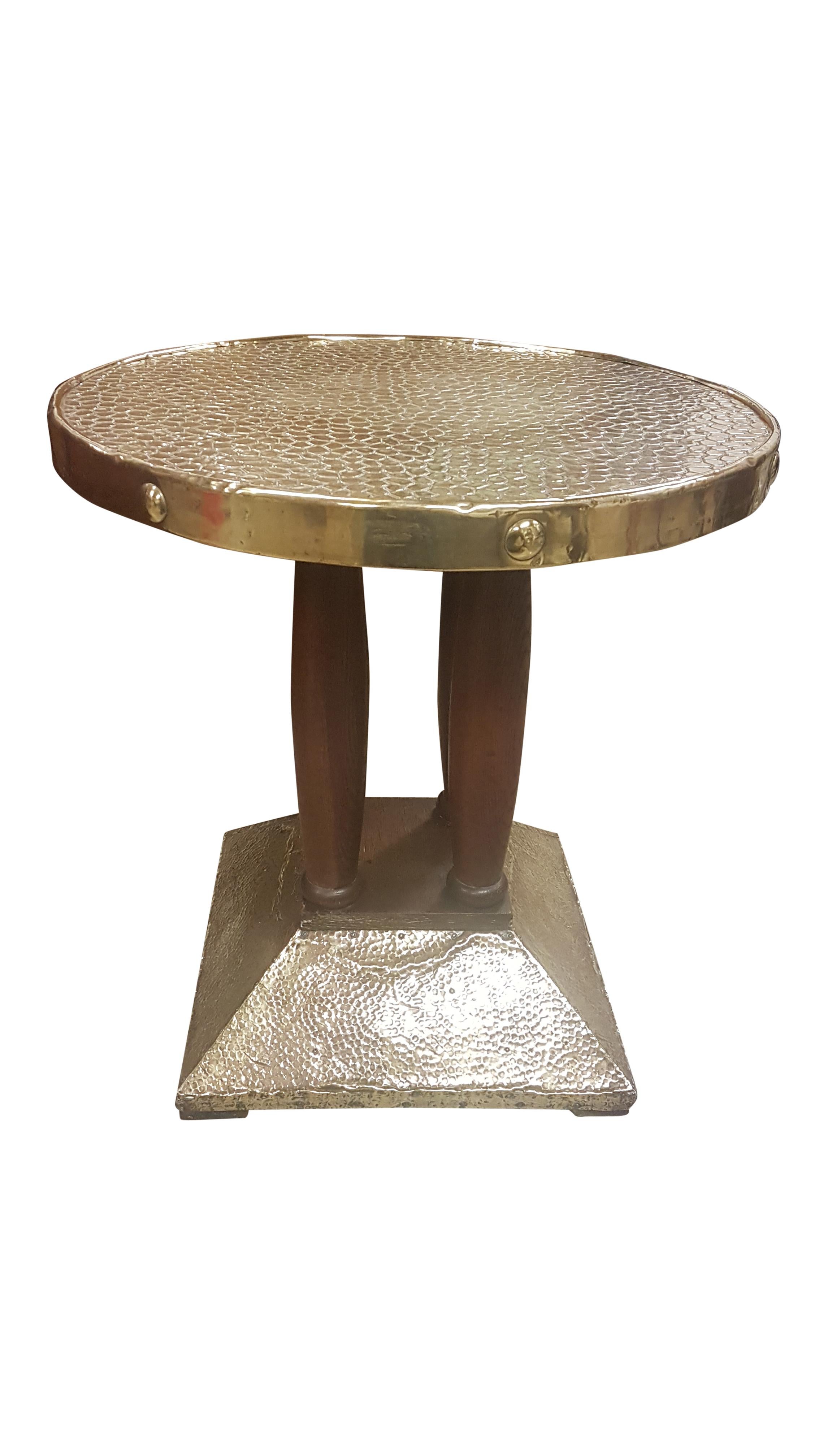 A great quality strong and sturdy oak and brass side table with quadruped solid oak column centre. The base is of pine covered in hand-hammered brass sheet and the top is covered in brass that is in the design of crocodile skin. 
The oak sections