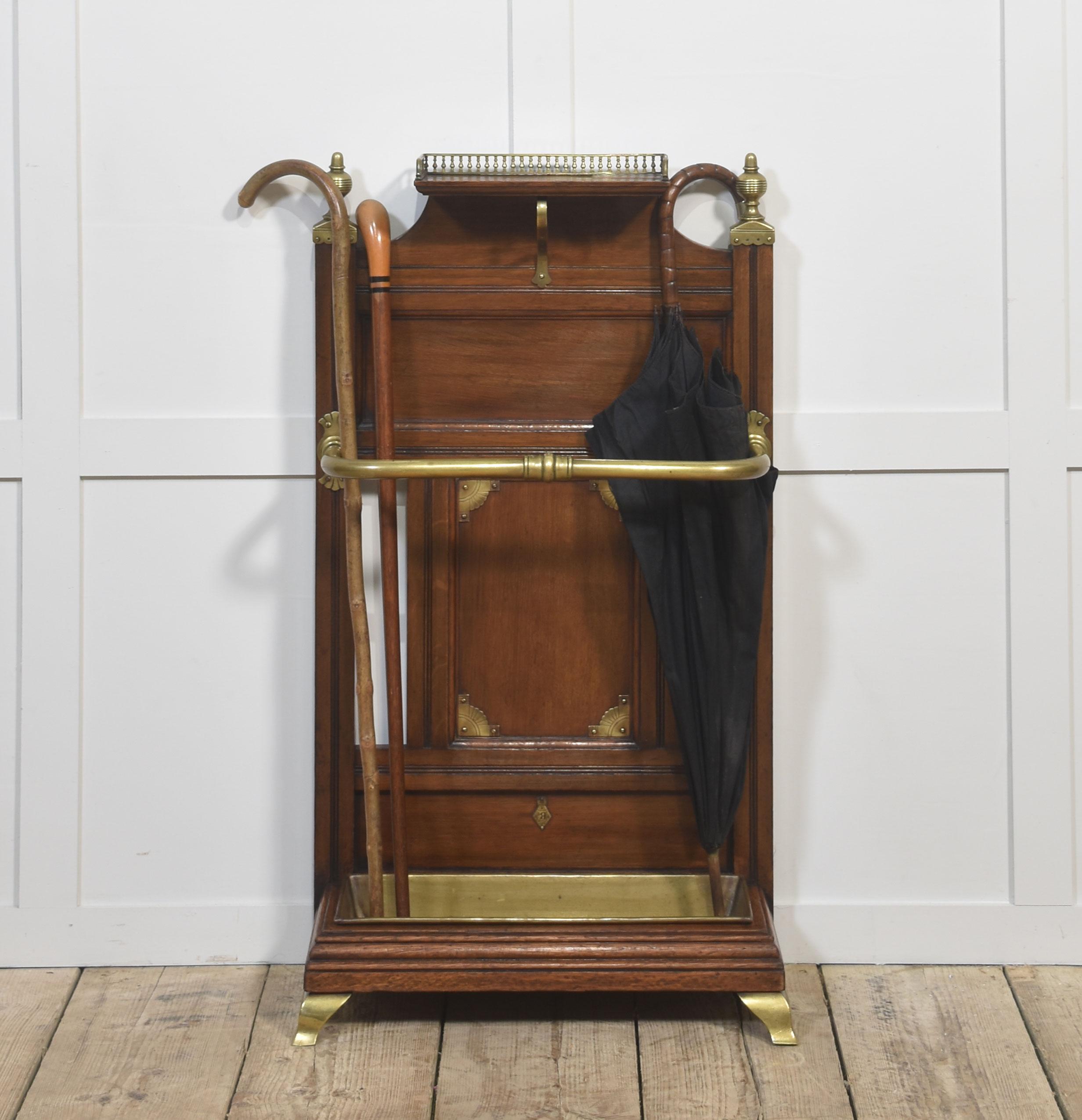 A superb late Victorian oak and brass umbrella stand by James Shoolbred & Co., renowned London cabinetmakers celebrated for their high-quality furnishings in the Aesthetic and late Victorian styles.
This fine example features a solid oak frame with