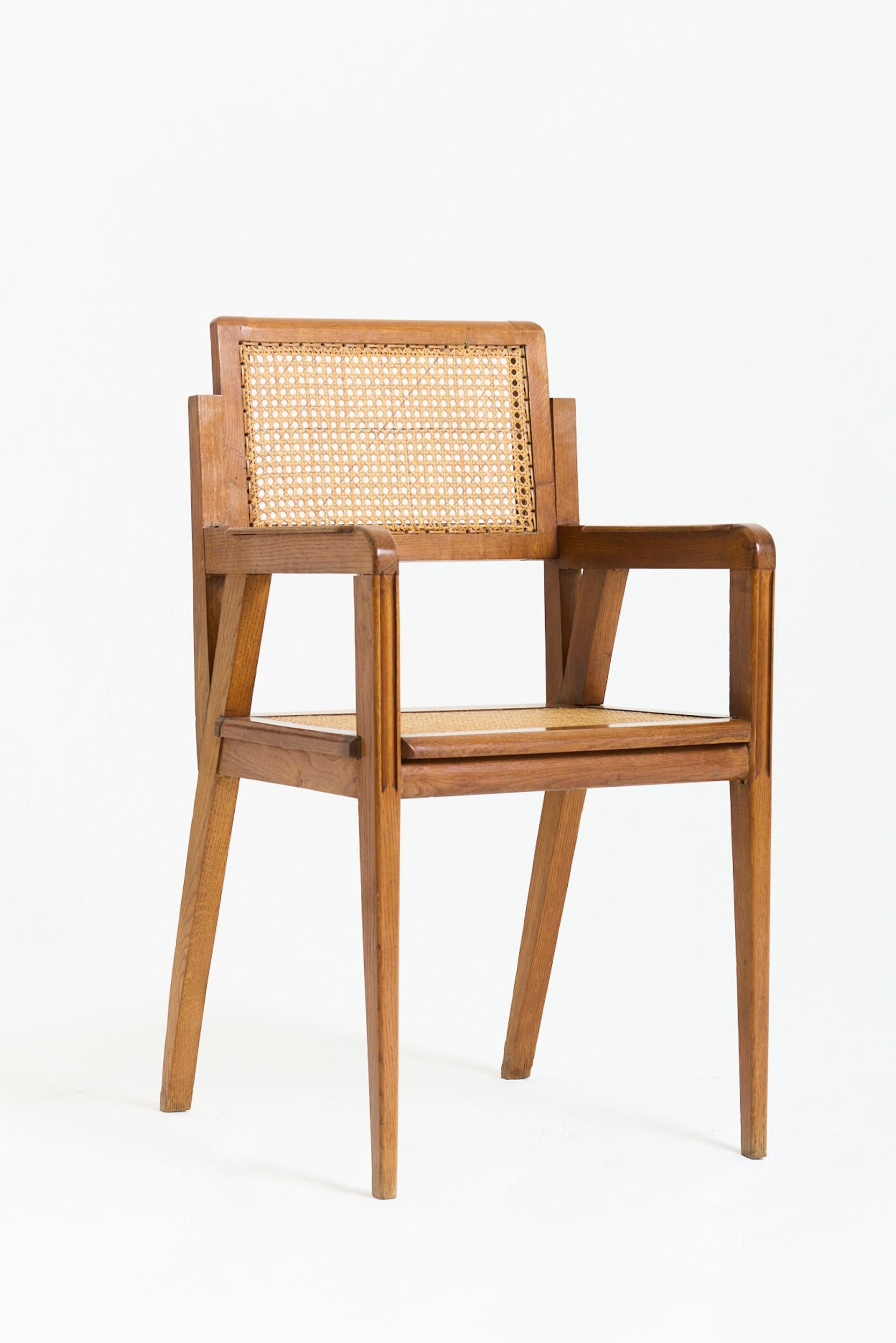 An oak and cane armchair
France, Circa 1950
