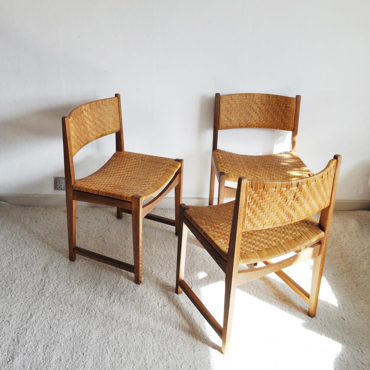 Set of three dining chairs model 351 designed by Peter Hvidt & Orla Mølgaard-Nielsen made of solid oak, woven cane seat and backpiece. Original cane in a good condition. Manufactured by Søborg Møbler, 1959.
Patinated with signs of wear consistent