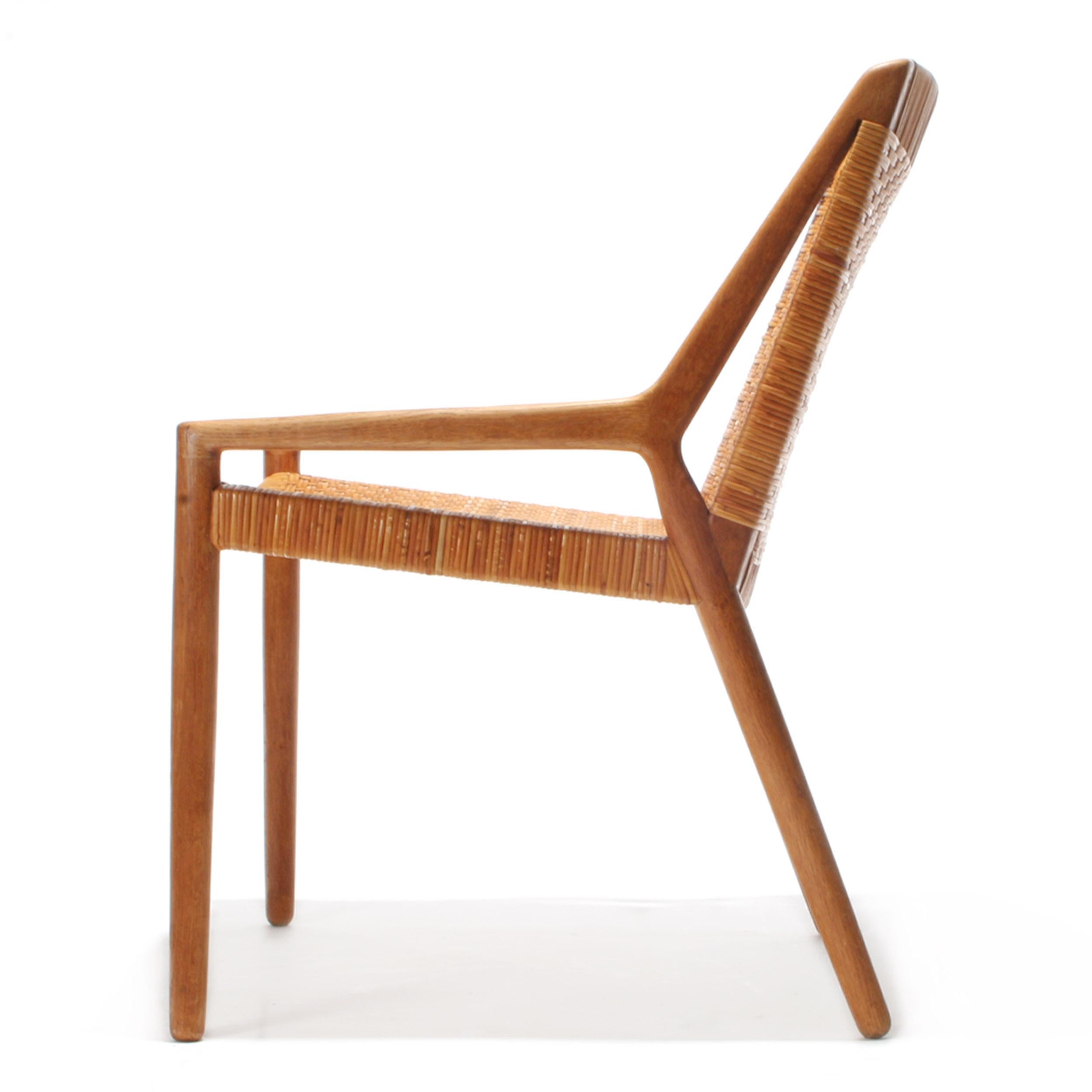 A rare Scandinavian Modern armchair designed by Ejner Larsen & Aksel Bender Madsen. The design features oak and caned in a modern linear form. Produced by Willy Beck in Denmark, circa 1950s.