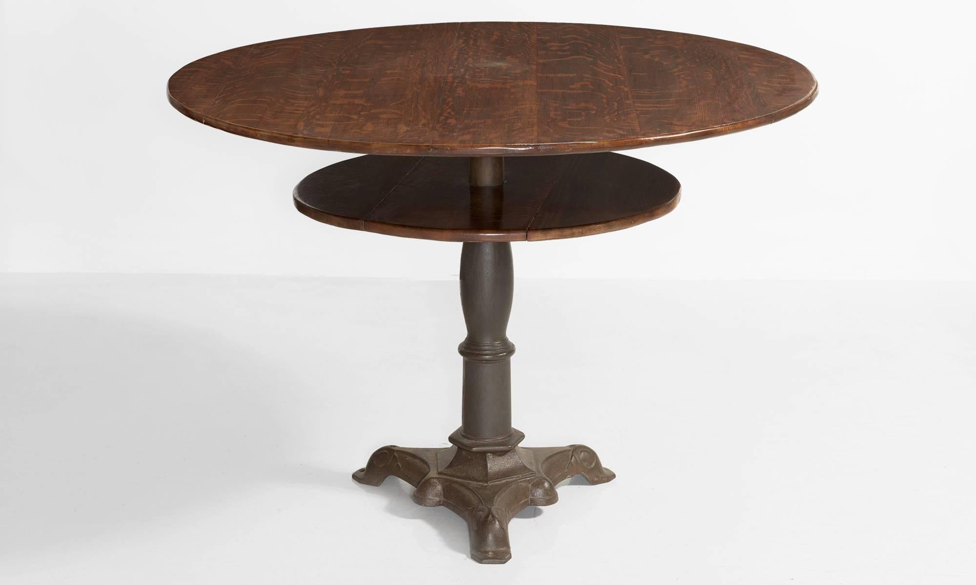 Oak and cast iron centre table, America, circa 1890

Centre table with circular top and unique shelf on tripod base.