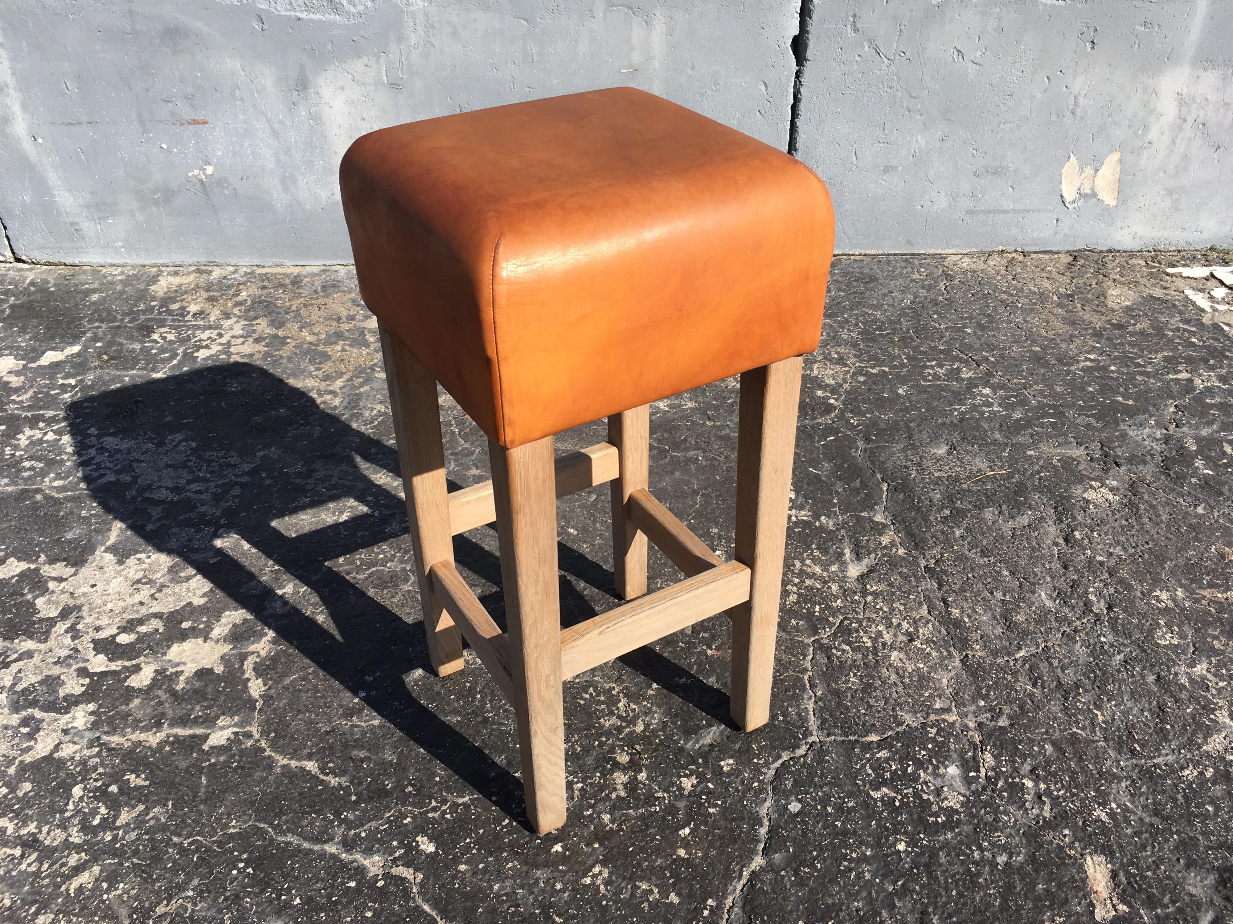 Beautiful and extremely well made bar stools, solid oak and beautiful cognac leather with a great patina. The leather is very thick and the oak construction will last forever.
 